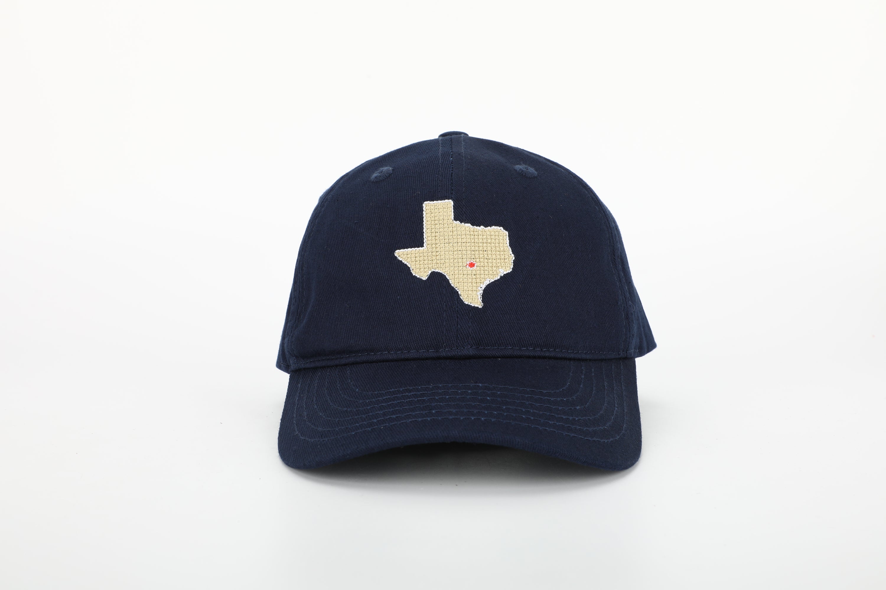 A stylish Texas Hat for children featuring needlepoint embroidery and an adjustable cognac leather strap.