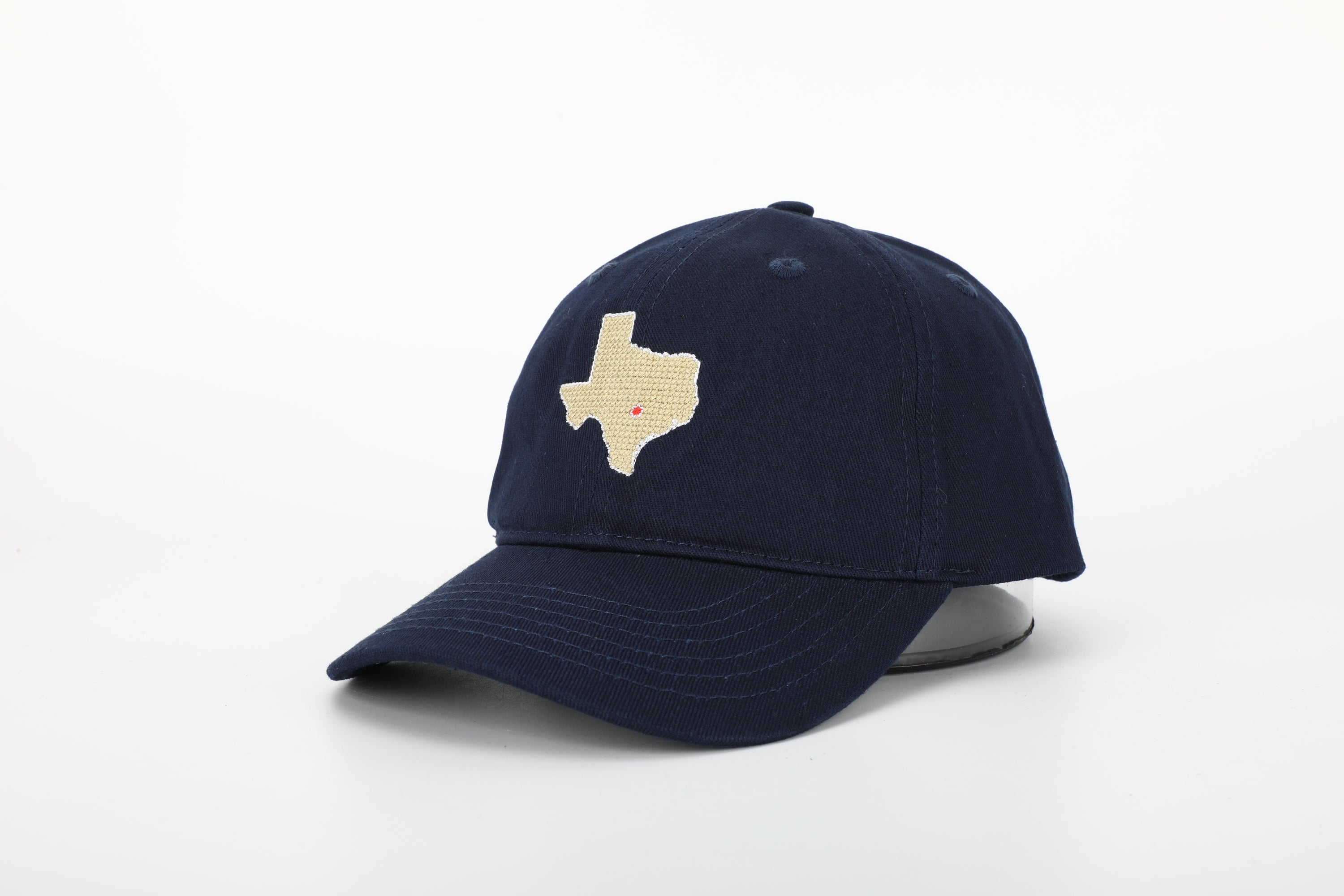 A stylish Texas Hat for children featuring needlepoint embroidery and an adjustable cognac leather strap.