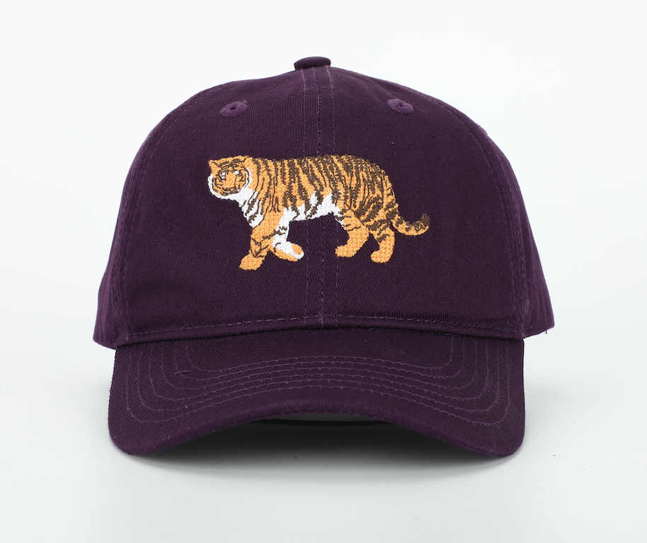 A stylish Tiger Hat for children featuring needlepoint embroidery, cognac leather adjustable strap, and brass embossed buckle.