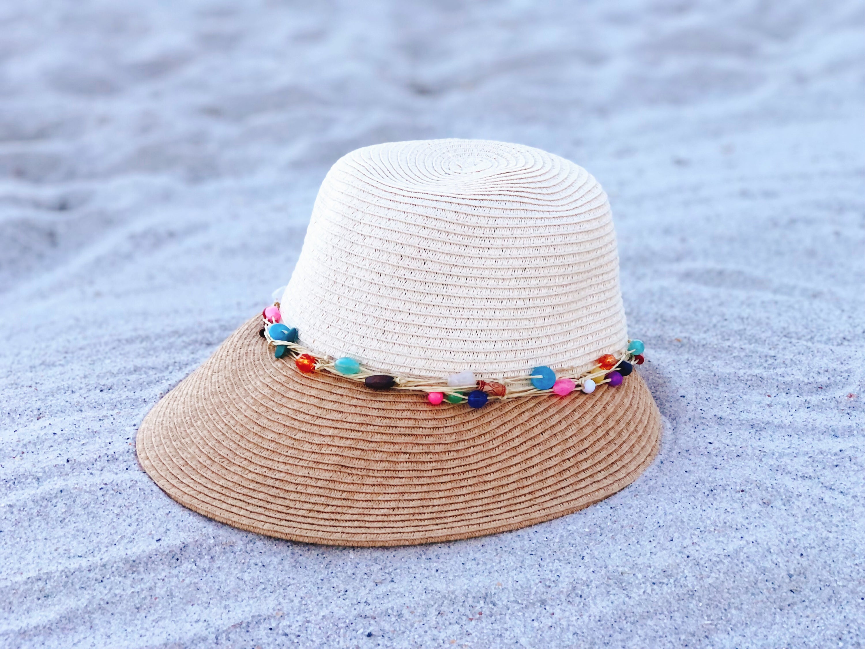 Two-tone beaded visor hat with adjustable drawstring and 4-inch brim, perfect for sun protection.