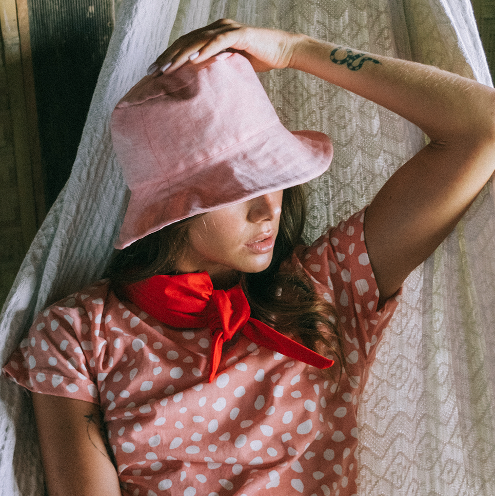 WATU Seaside Linen Bucket Hat in Salt Pink, showcasing its vibrant color and stylish design, perfect for sunny days.