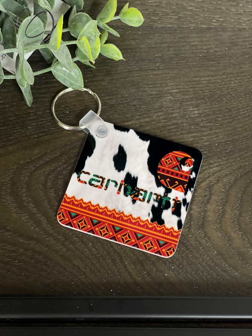 Aztec Cowhide Carhartt Keychain featuring a vibrant design on both sides, made from durable plastic, measuring 2.25 inches square.