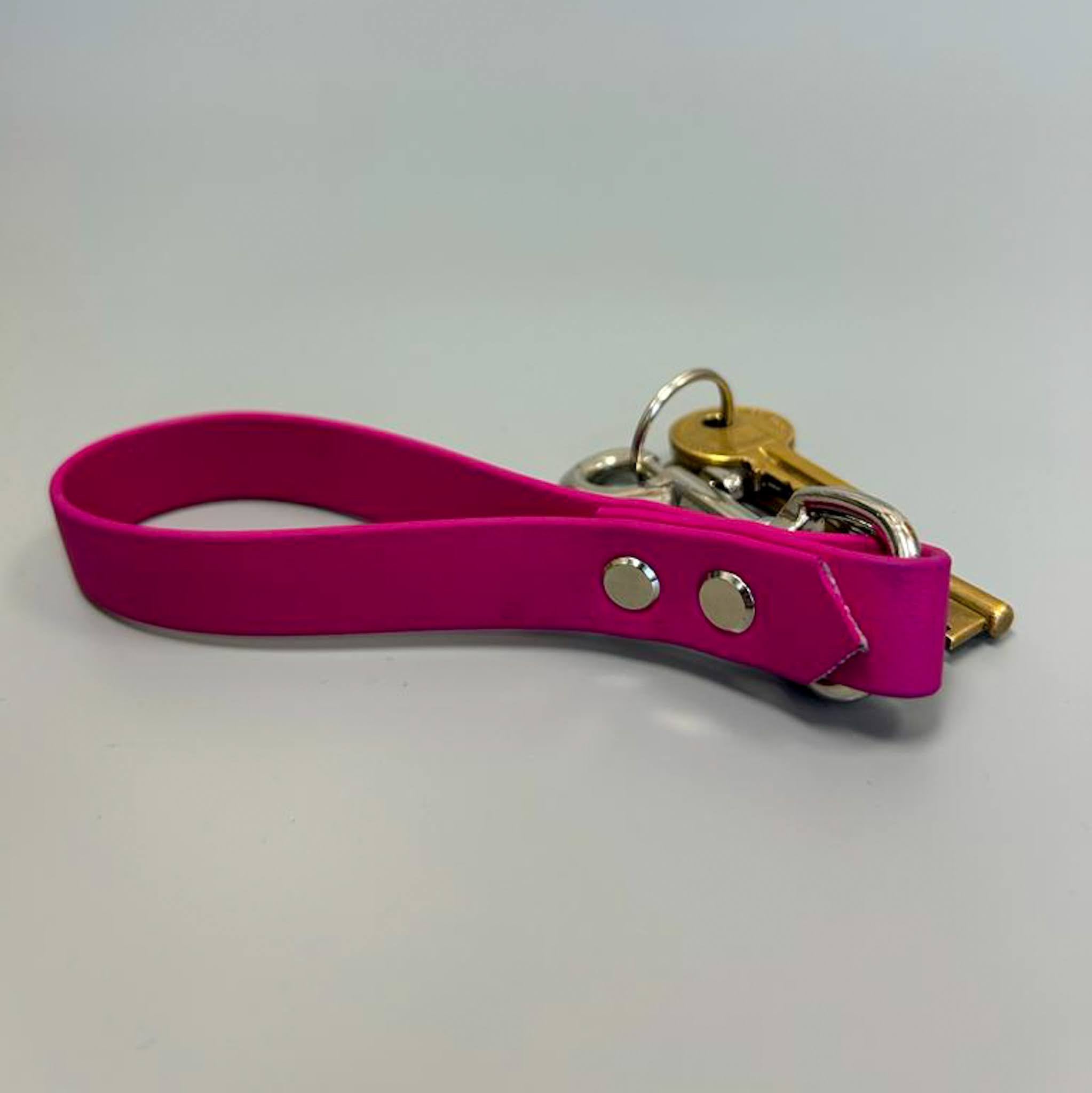 A colorful BioThane key ring designed to match dog collars, showcasing its durable and waterproof material.