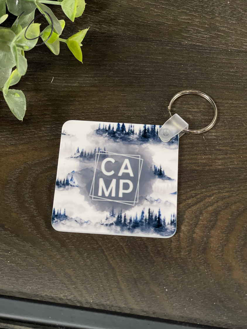 A durable Camp Keychain featuring a vibrant double-sided design, made from high-quality plastic, measuring 2.25 inches by 2.25 inches.