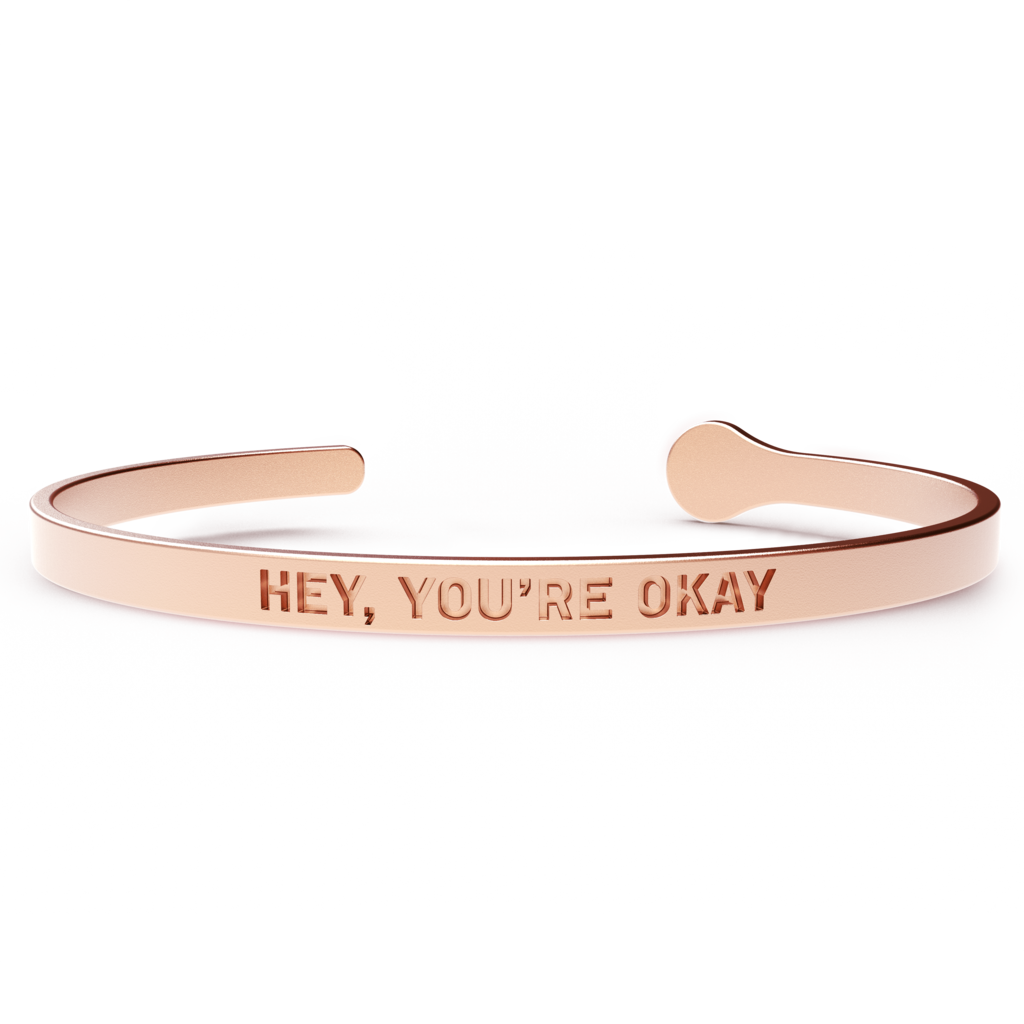 A stylish HEY, YOU'RE OKAY bracelet made of hypoallergenic stainless steel with a 24k gold coating, designed to fit most wrist sizes.