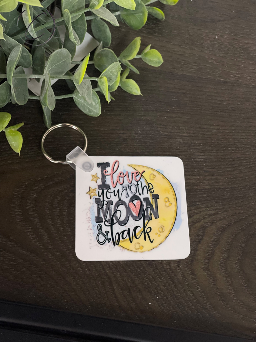 I Love You To The Moon Keychain featuring a double-sided design, made from durable plastic, measuring 2.25 inches by 2.25 inches.