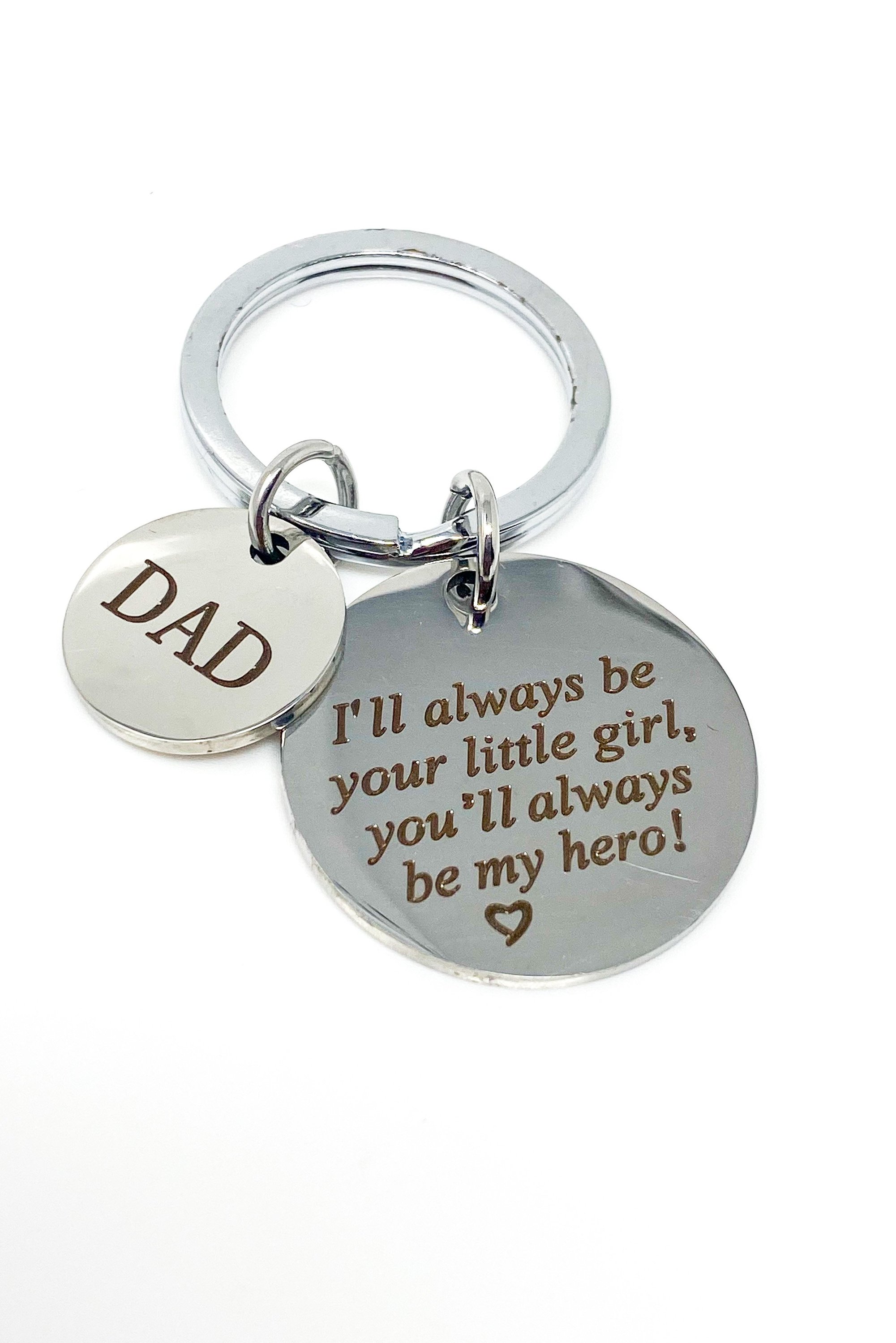 A silver keychain engraved with 'Dad My Hero', made from high-quality zinc alloy, showcasing its elegant design and durability.