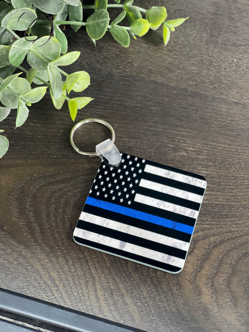 Durable Thin Blue Line Keychain featuring a double-sided design, measuring 2.25 inches by 2.25 inches, made from high-quality plastic.