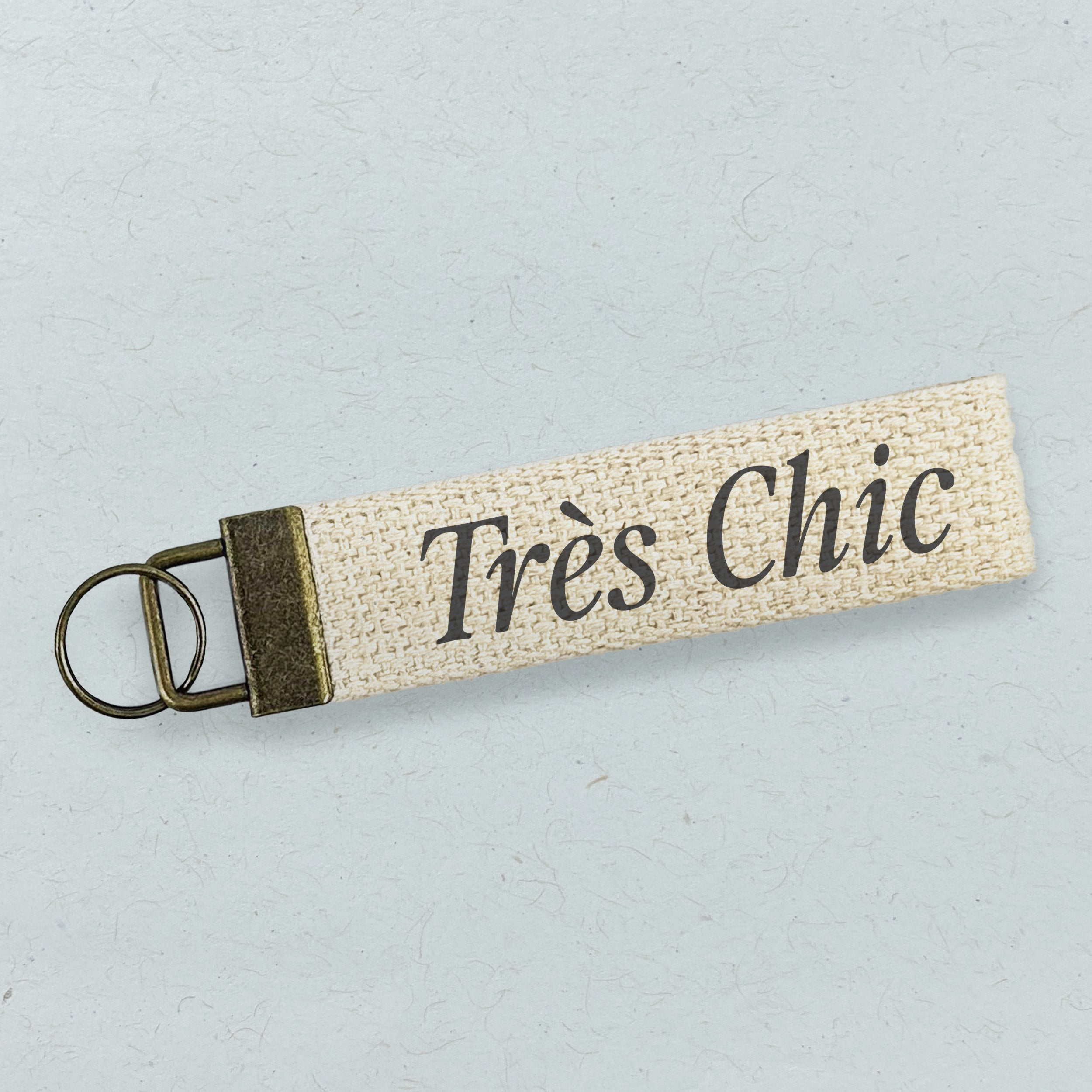 Tres Chic Canvas Key Fob made of heavy-duty cotton with bronze hardware, featuring a natural color design.