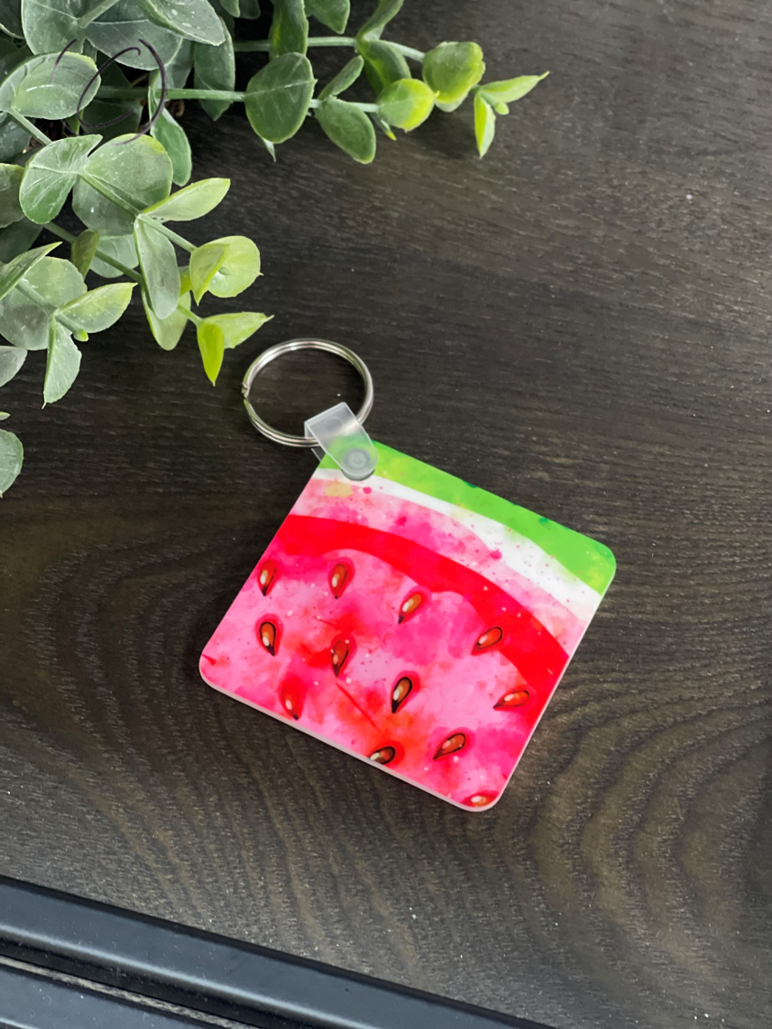 A vibrant Water Color Watermelon Keychain featuring a colorful watermelon design on both sides, made from durable plastic.