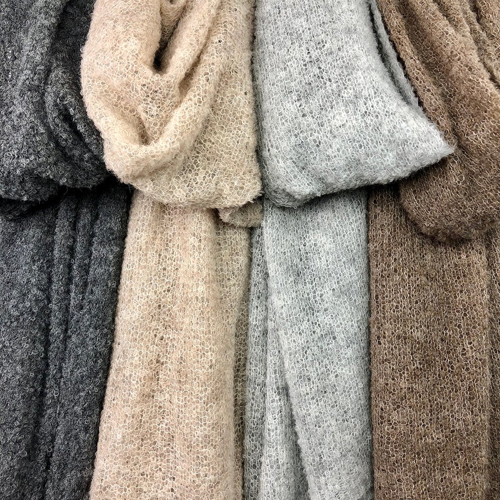 Almond Ultra Plush Alpaca Scarf displayed elegantly, showcasing its soft texture and oversized design, perfect for warmth and style.