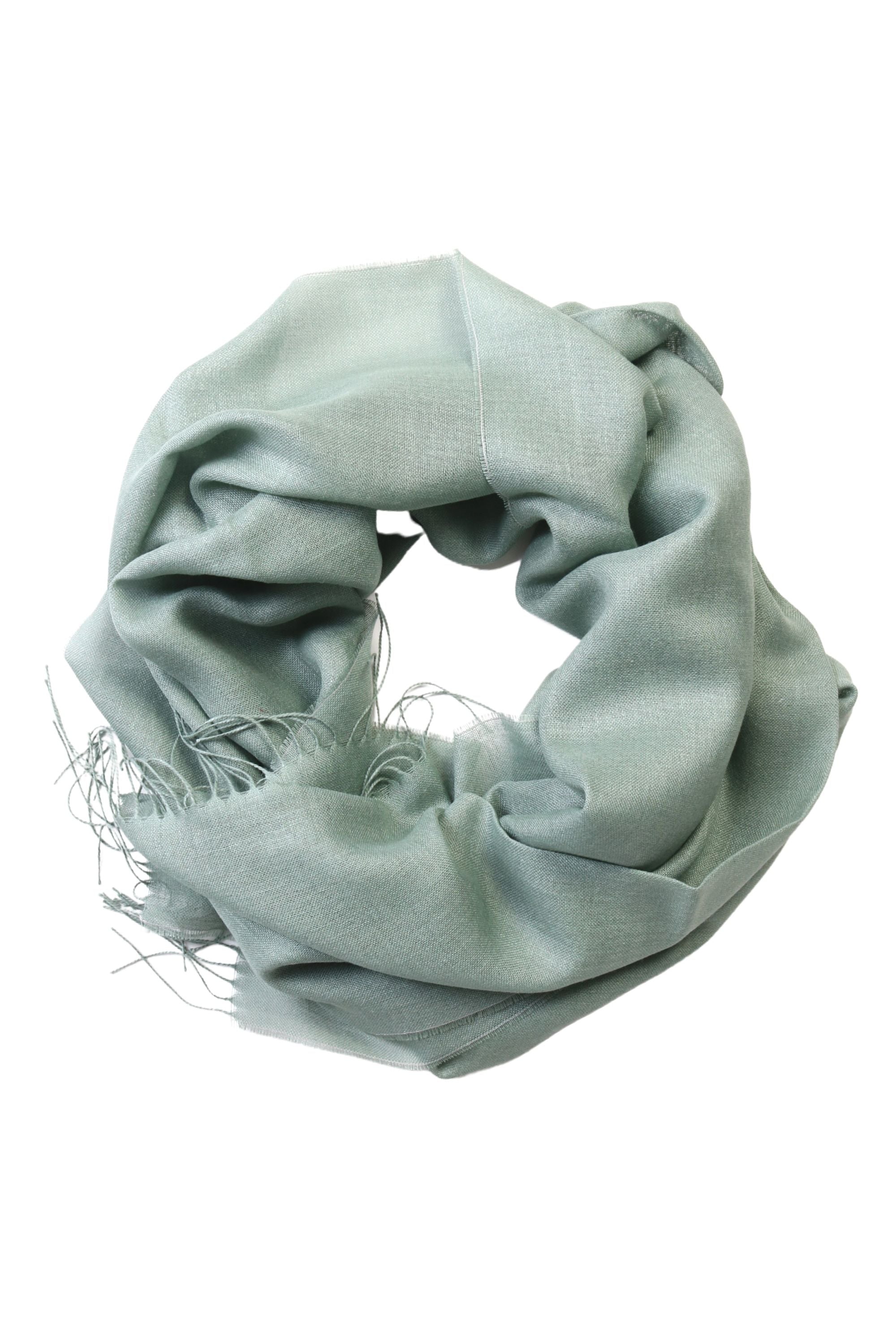 Luxurious green shawl made from 70% baby alpaca wool and 30% silk, showcasing its soft texture and elegant design.