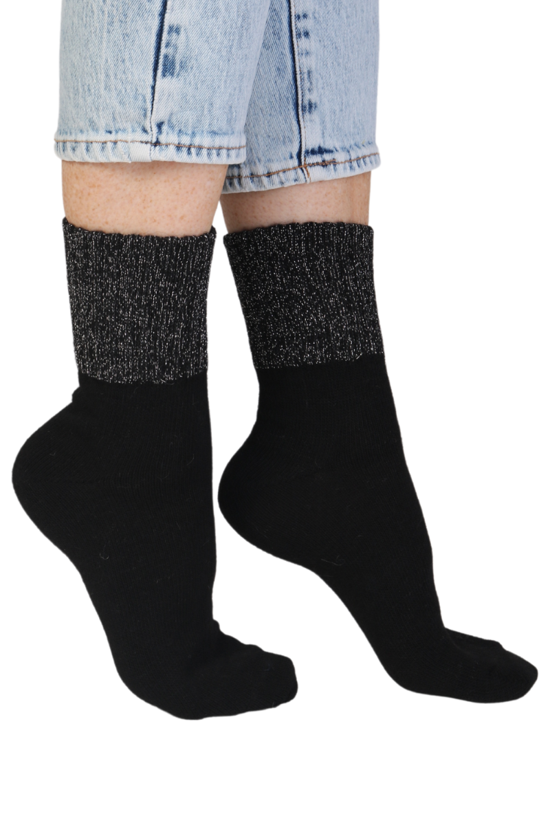 A pair of black alpaca wool socks with a glittery ribbed edge, showcasing their luxurious texture and stylish design.