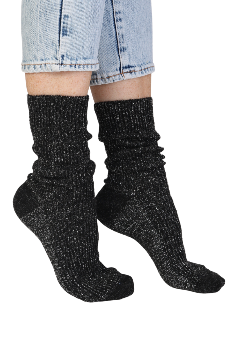 A pair of luxurious black sparkly socks made from alpaca wool, showcasing their soft texture and elegant design.