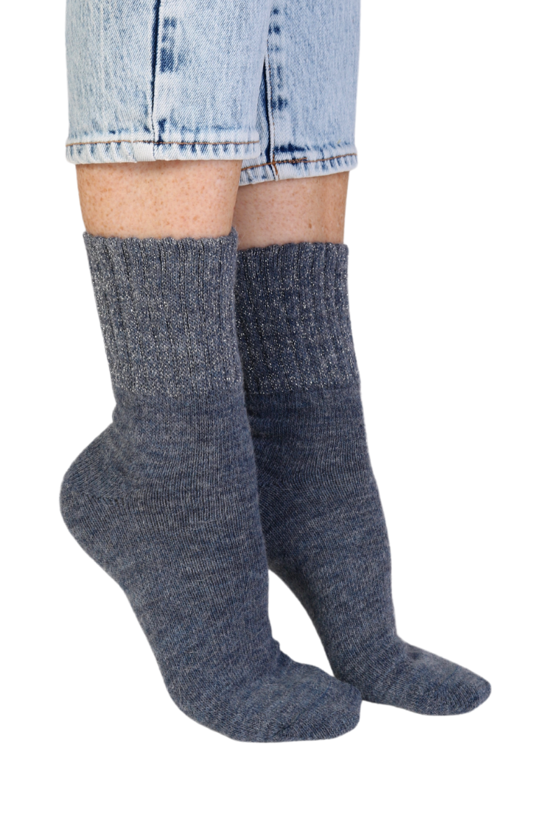 A pair of luxurious blue socks made from alpaca wool, featuring a sparkling ribbed edge, perfect for women's fashion.