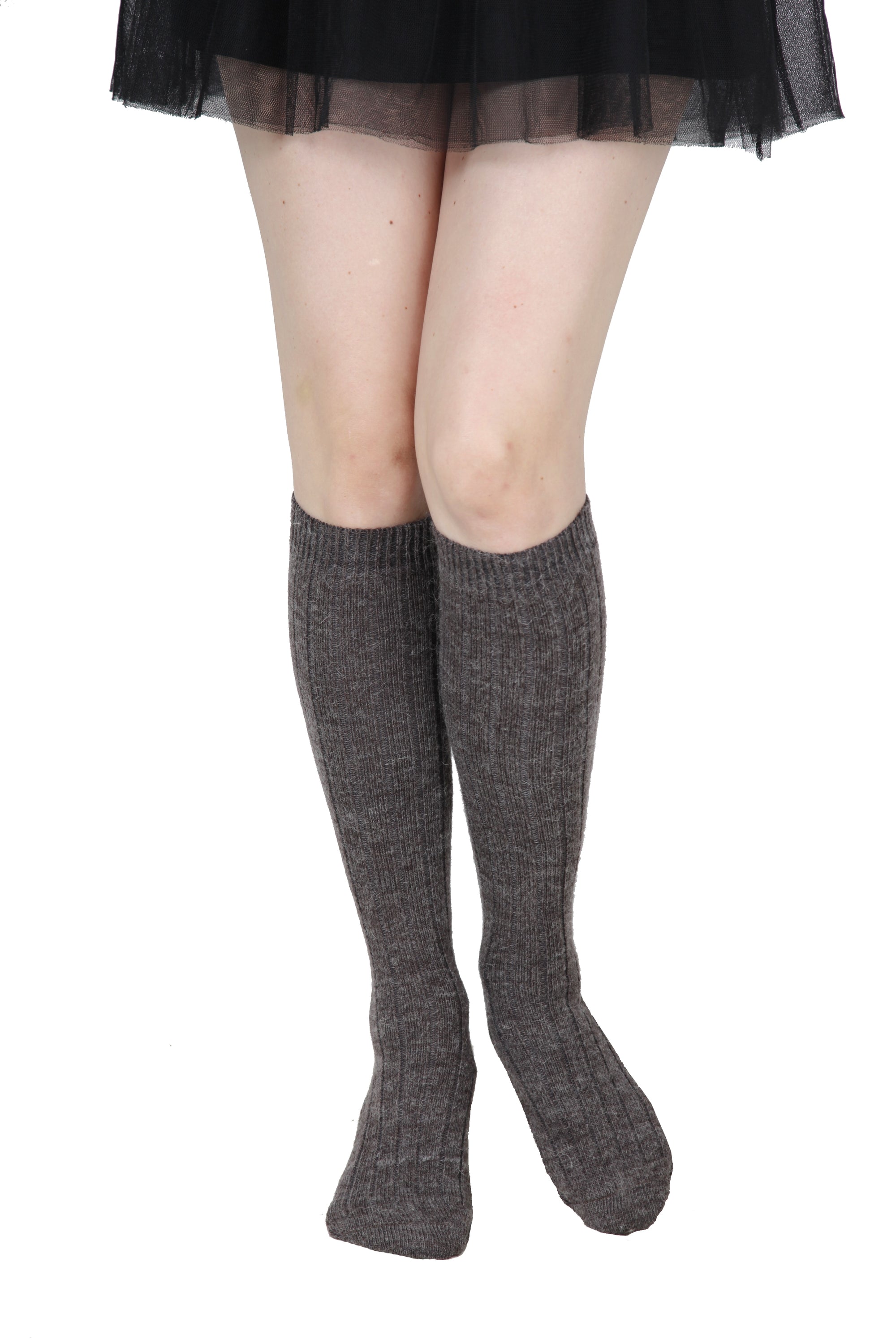 A pair of luxurious brown knee high socks made from soft alpaca wool, showcasing their elegant texture and warmth.