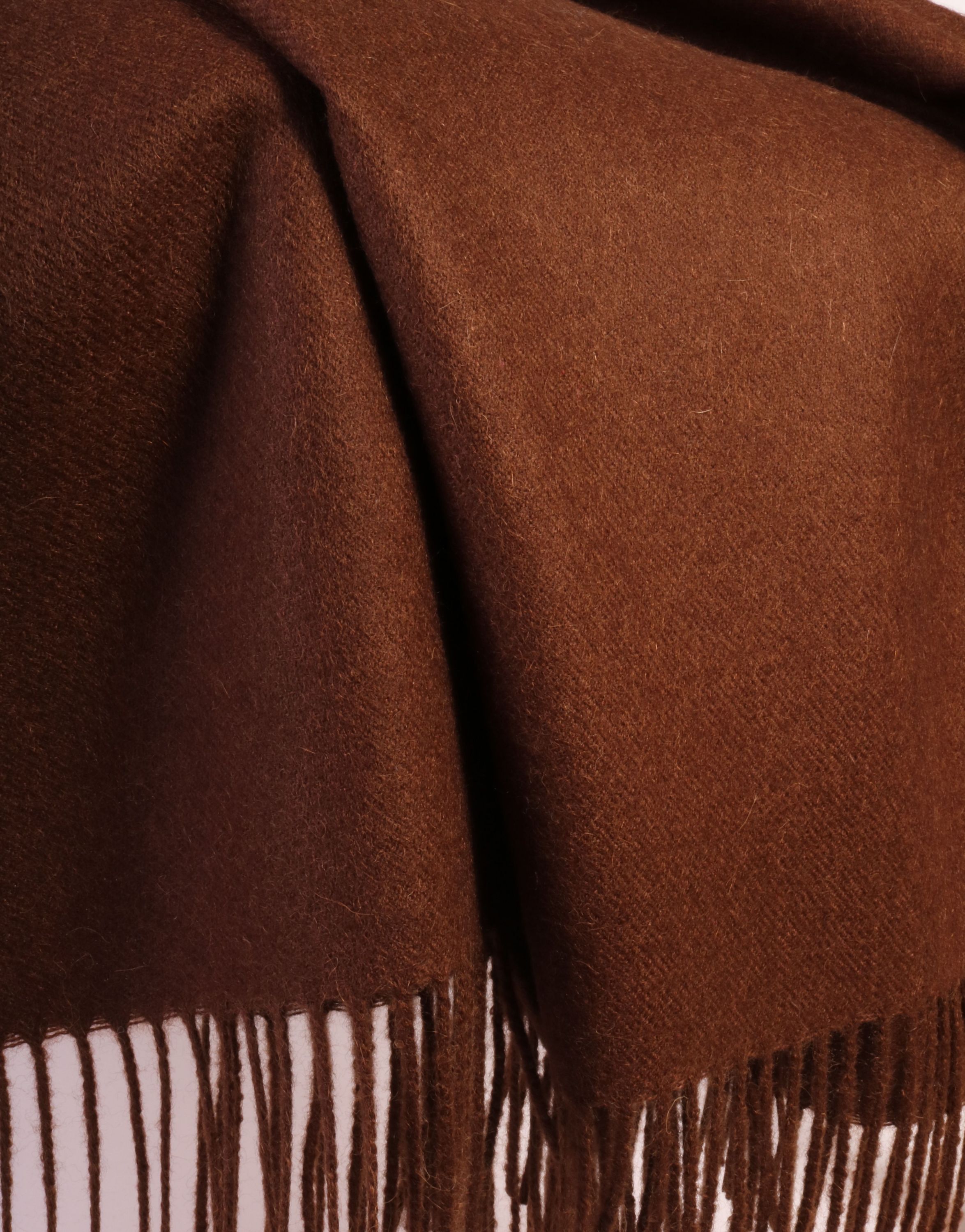 Luxurious dark brown plaid made from 100% alpaca wool, showcasing its soft texture and elegant design.