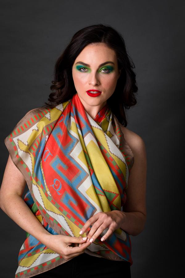 Armenian Alphabet Scarf #3 featuring pastel colors and traditional carpet motifs, elegantly displayed in a gift box.