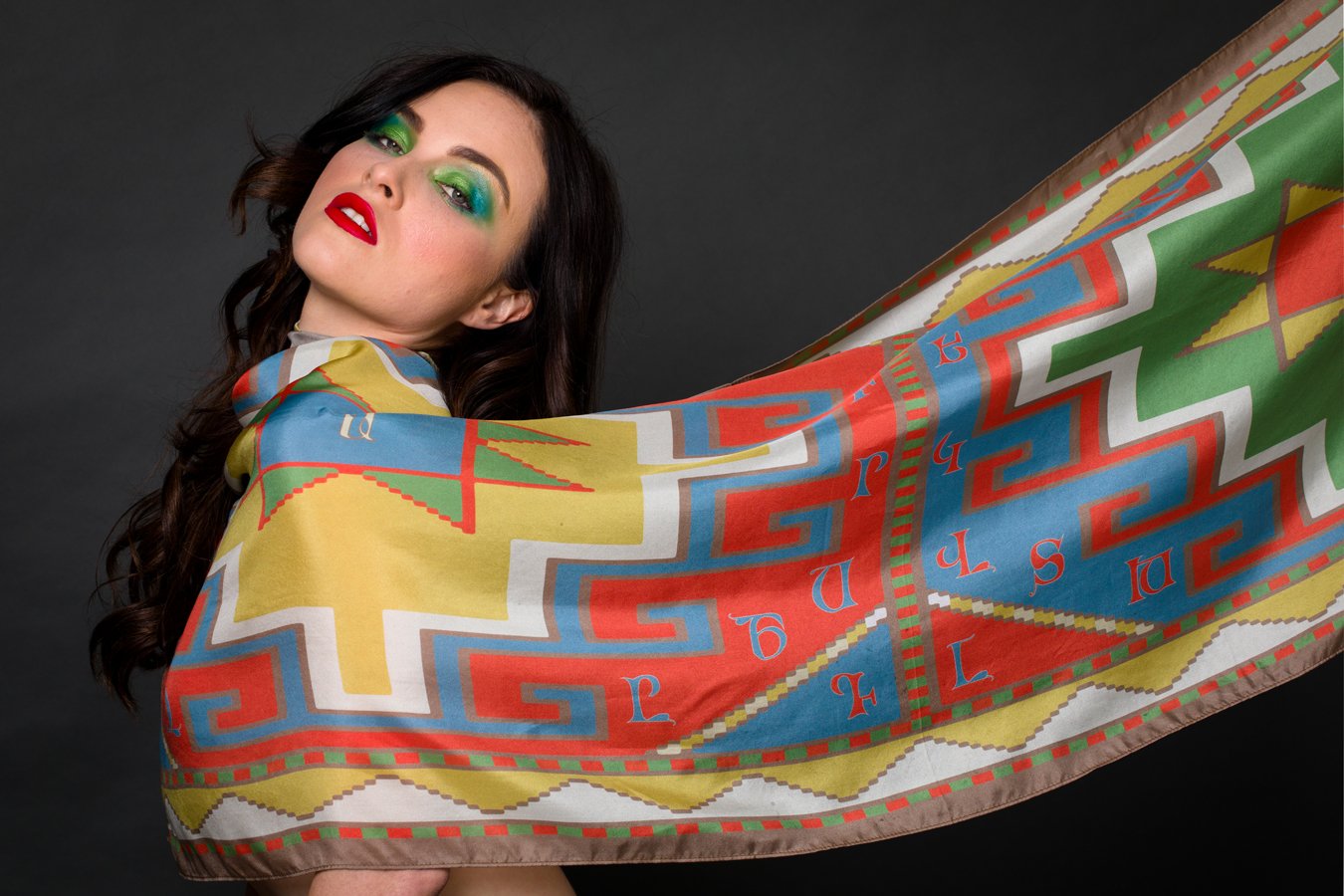 Armenian Alphabet Scarf #3 featuring pastel colors and traditional carpet motifs, elegantly displayed in a gift box.