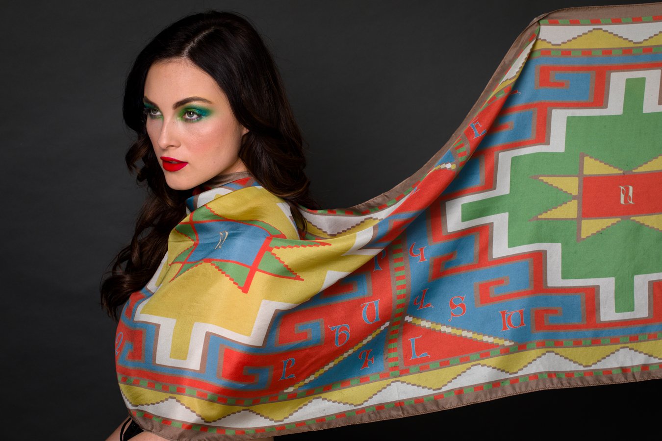 Armenian Alphabet Scarf #3 featuring pastel colors and traditional carpet motifs, elegantly displayed in a gift box.