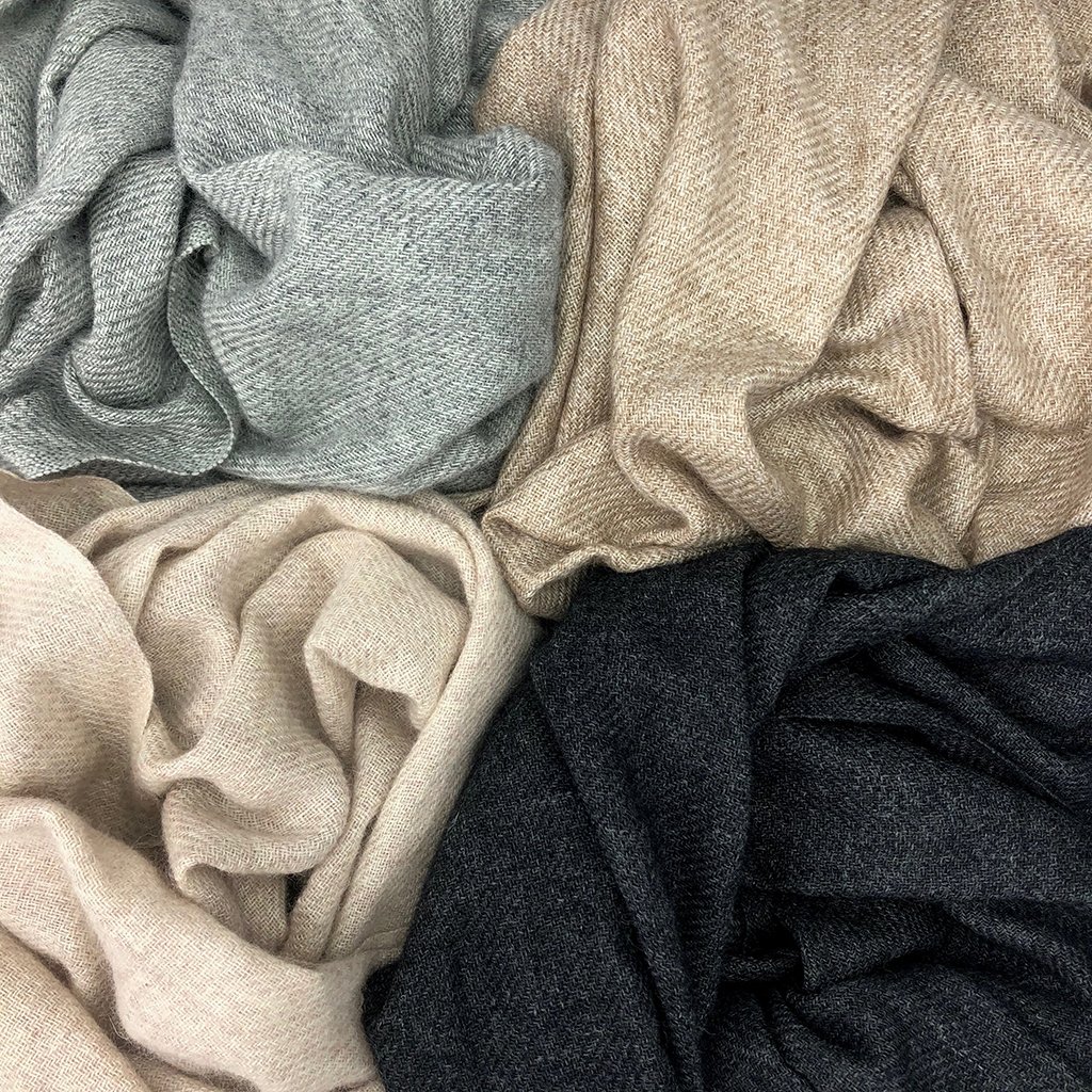 Various colored folded wool fabrics.