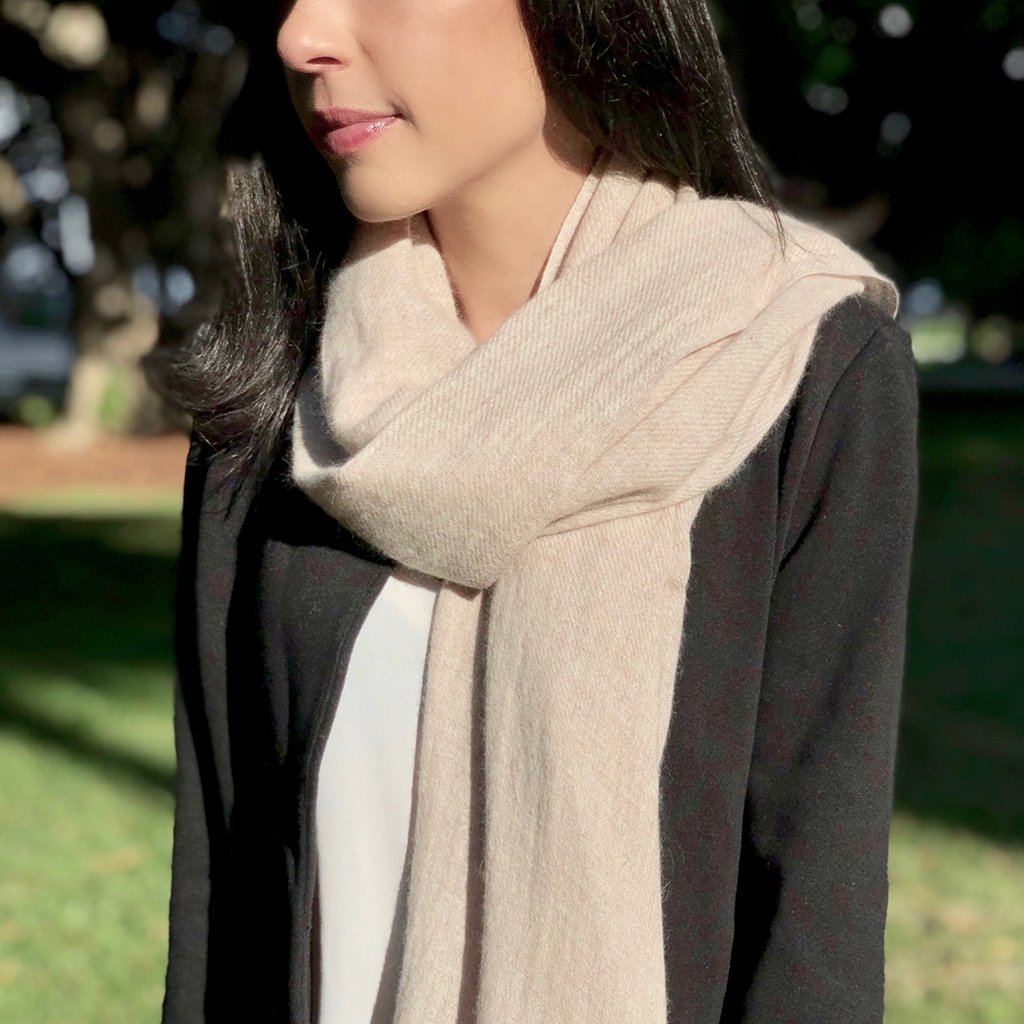 Woman wearing a beige scarf.