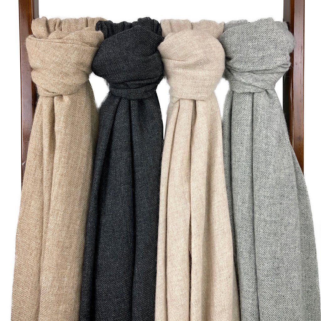 Four wool scarves in neutral colors.