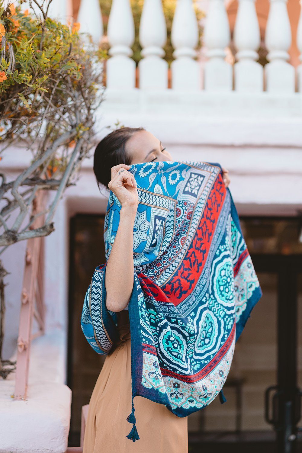 A cozy Bohemian blanket scarf with tassel detailing at the corners, showcasing its soft fabric and generous size.