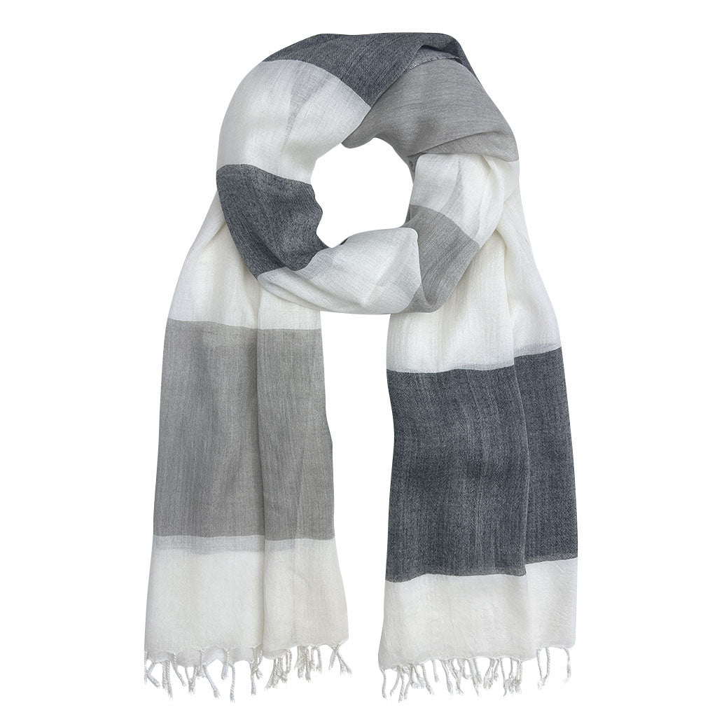 A beautifully hand-loomed Bold Stripe Milk Yarn Scarf showcasing unique stripes and soft texture, made from sustainable milk protein fibers.