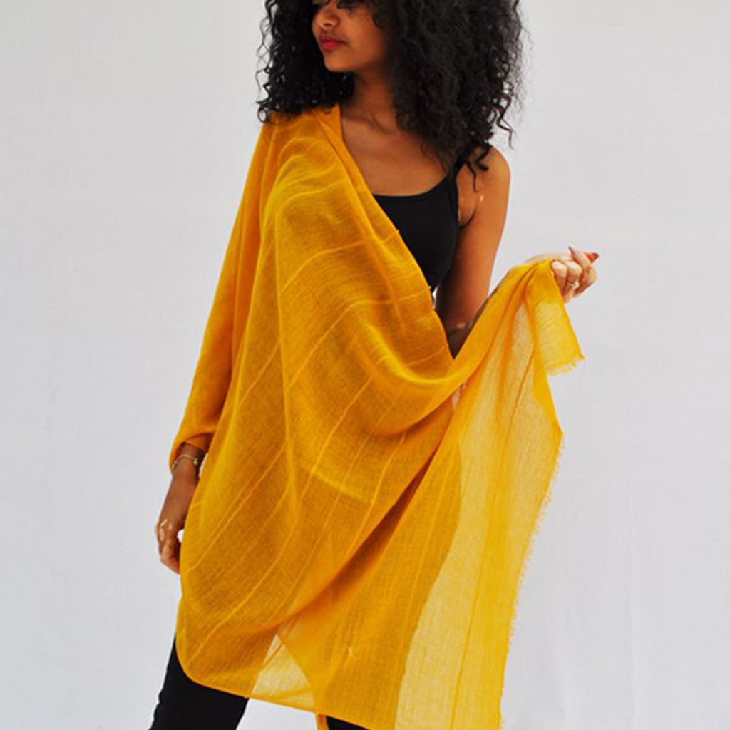 A vibrant oversized Classic Cotton Wrap Scarf hand-loomed from pure Ethiopian cotton, featuring an eyelash fringe edge.