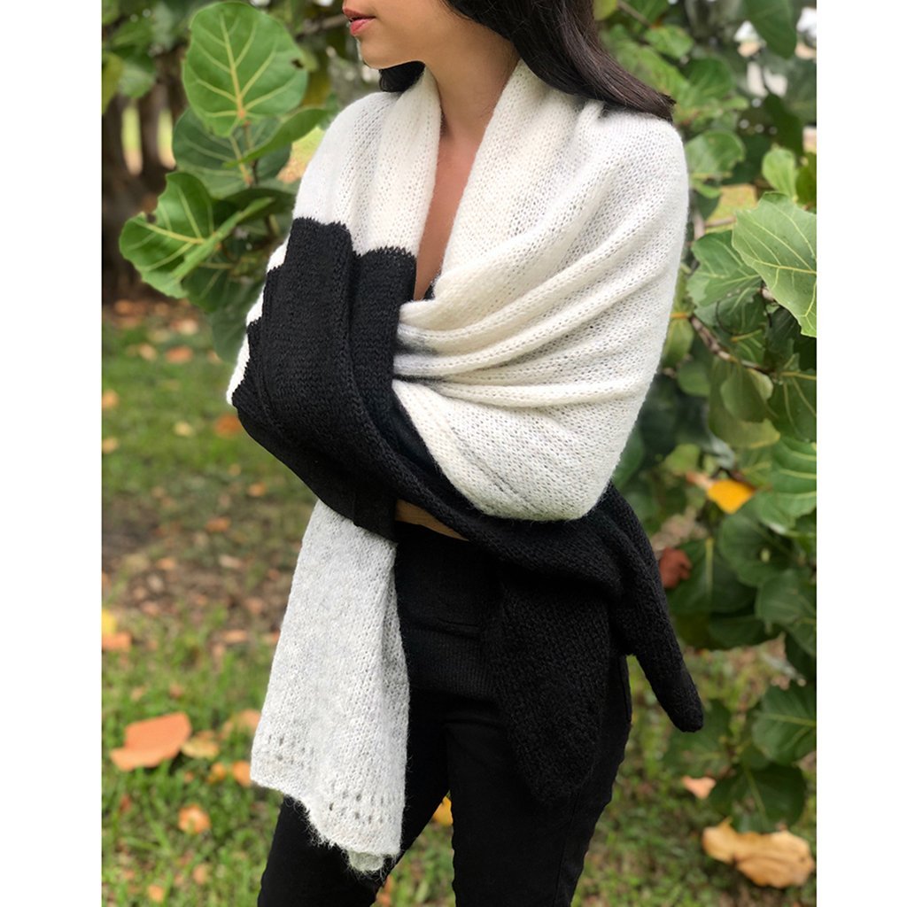 A luxurious Color Block Alpaca Wrap Scarf featuring a delicate eyelet design, showcasing shades of black, gray, and snow, perfect for layering.