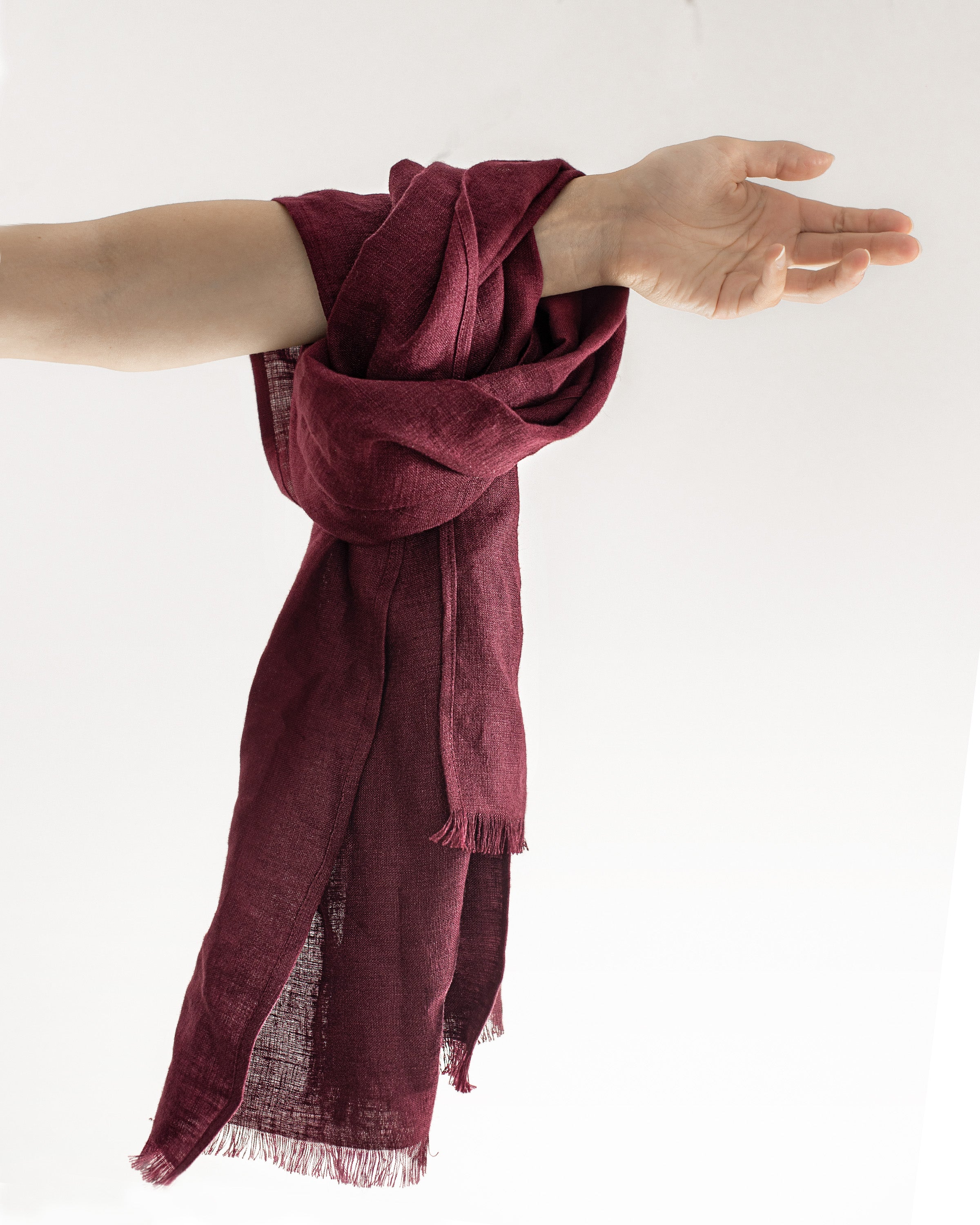 A stylish Dark Plum linen scarf made from 100% stonewashed linen, showcasing its soft texture and vibrant color.