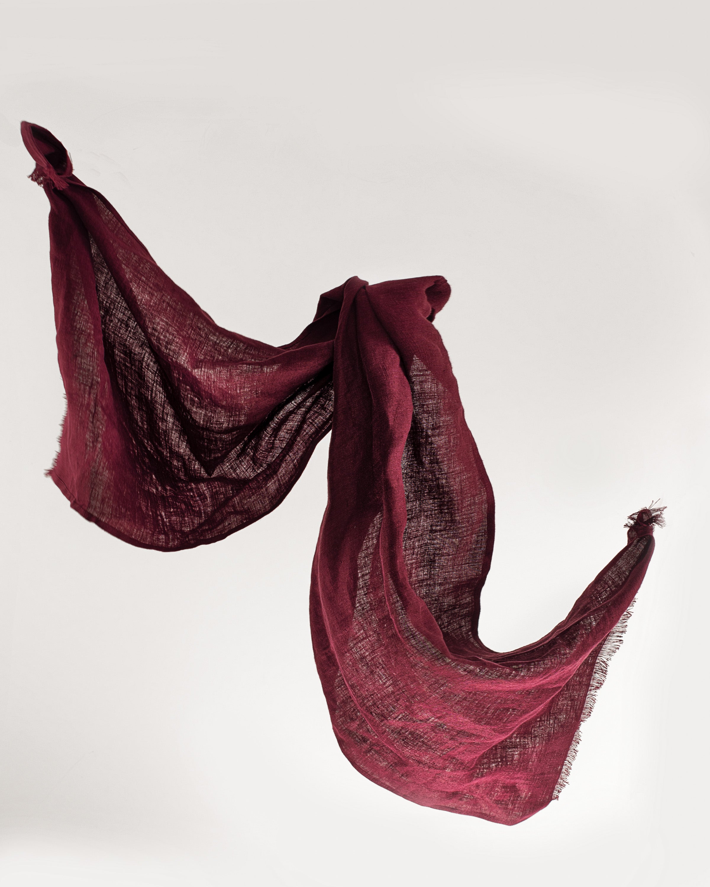 A stylish Dark Plum linen scarf made from 100% stonewashed linen, showcasing its lightweight and soft texture.