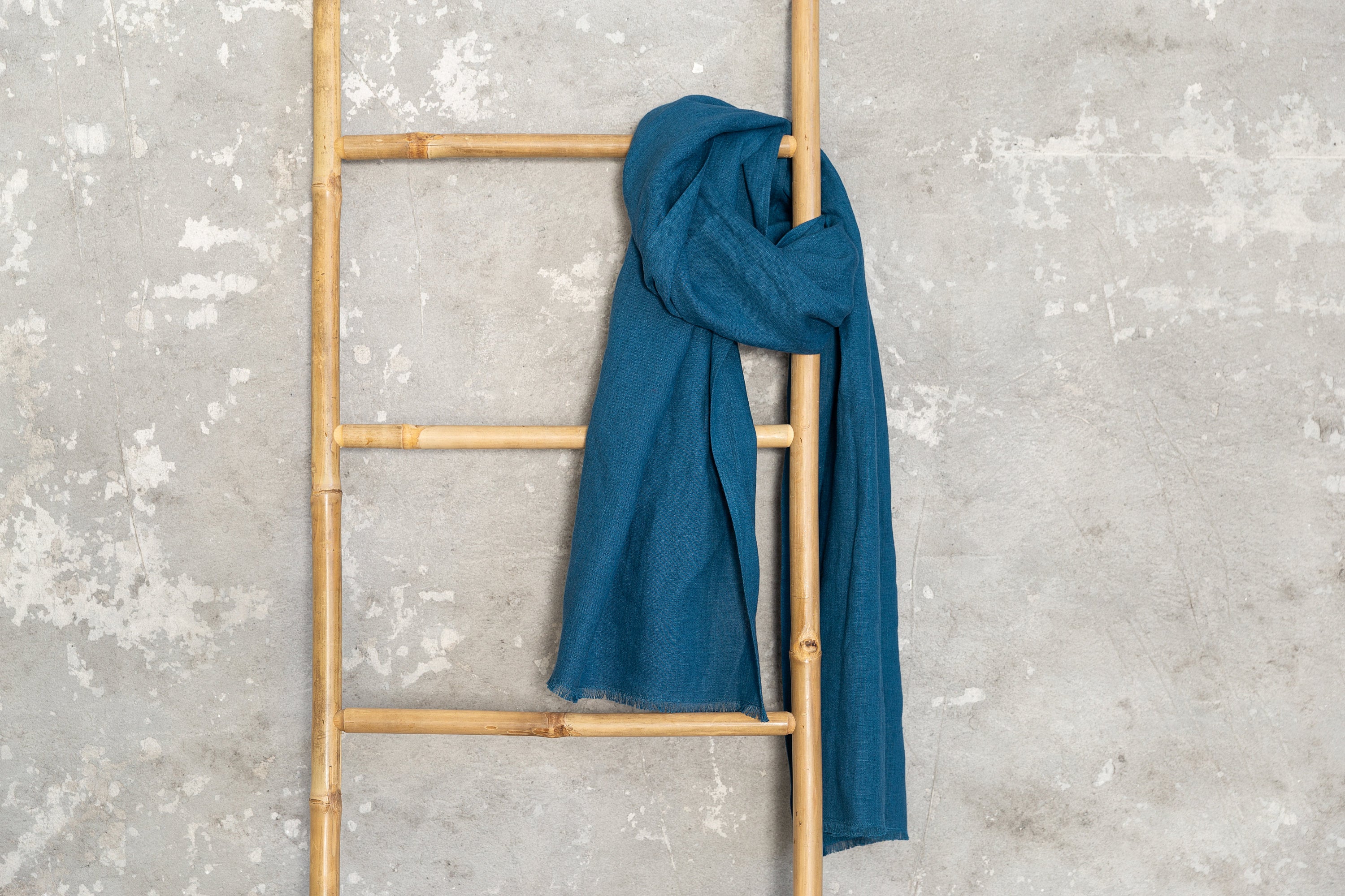 A stylish Dark Sea Blue scarf made from 100% stonewashed linen, showcasing its soft texture and elegant design.