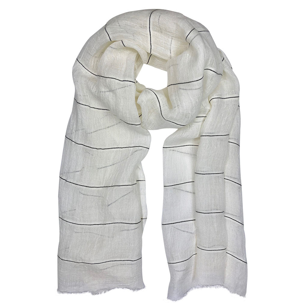 A beautifully handwoven Gauze Stripe Linen Wrap featuring raw eyelash fringe, showcasing its unique texture and design.