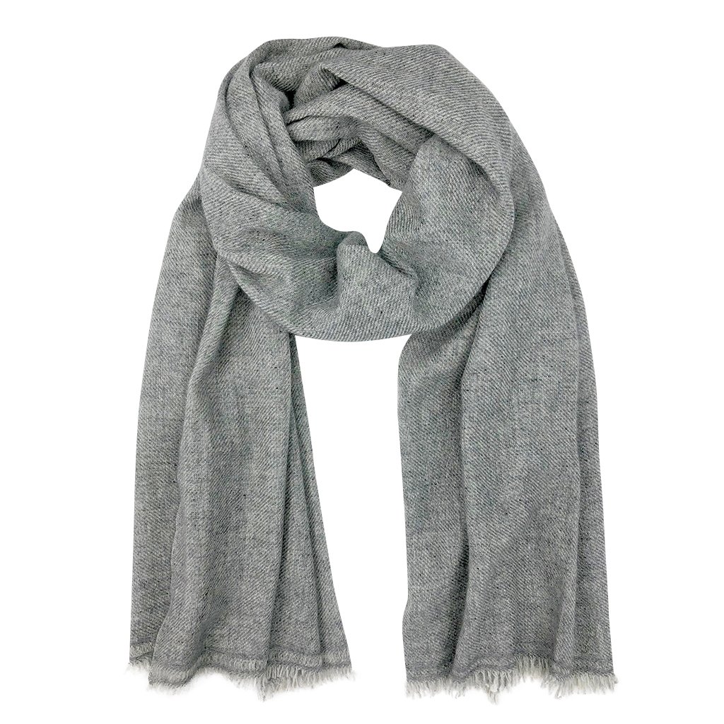 A luxurious gray handloom cashmere scarf, oversized and soft, showcasing unique patterns and textures, handmade by artisans in Nepal.