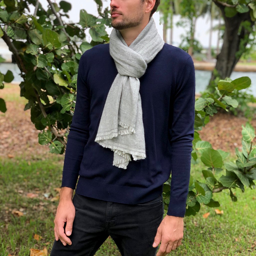 A luxurious gray handloom cashmere scarf, oversized and soft, showcasing unique patterns and textures, handmade by artisans in Nepal.