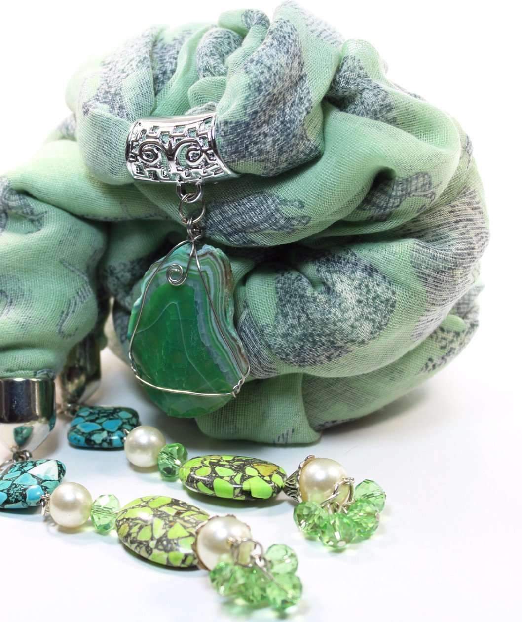 Grazing Elephants Pendant Scarf featuring light green color, silver tone pendant, faux pearls, and crystal accents.