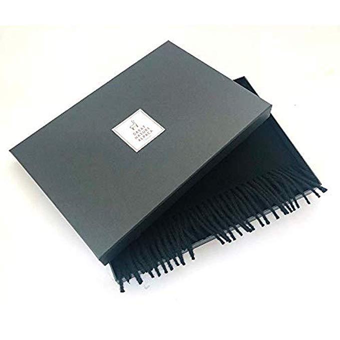 Luxurious black scarf made from 100% baby alpaca wool, showcasing its soft texture and elegant design.