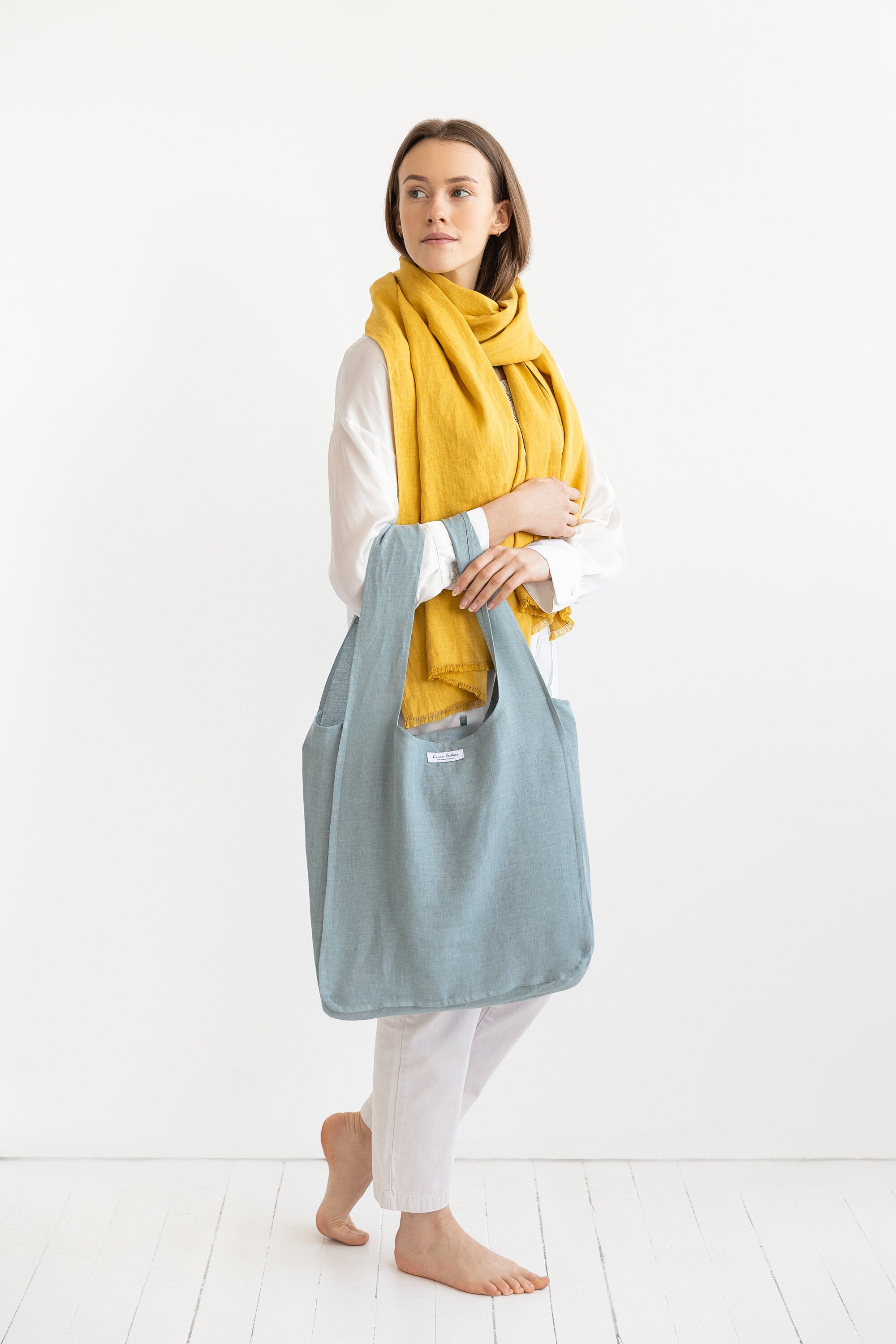 A vibrant Honey linen scarf made from 100% stonewashed linen, showcasing its soft texture and stylish design.