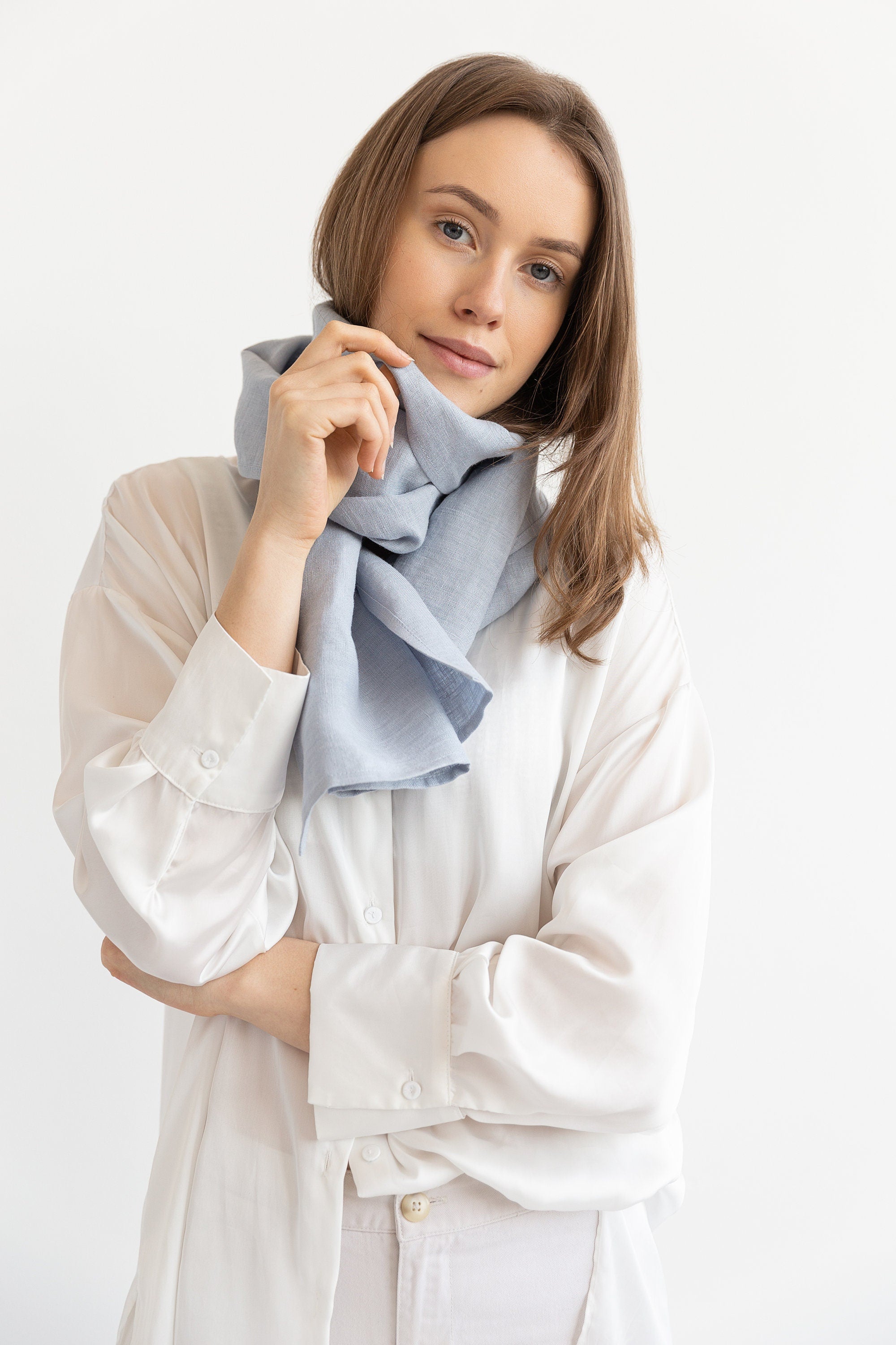 Elegant Ice Blue linen scarf made from 100% stonewashed linen, showcasing its soft texture and stylish design.