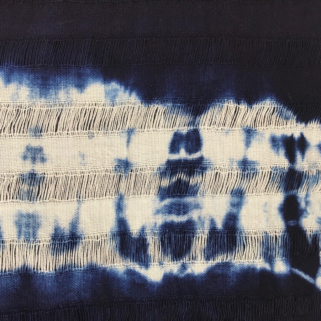 Indigo Stripe Scarf made from 100% natural cotton, hand dyed with indigo, showcasing its unique dark blue hue and oversized design.