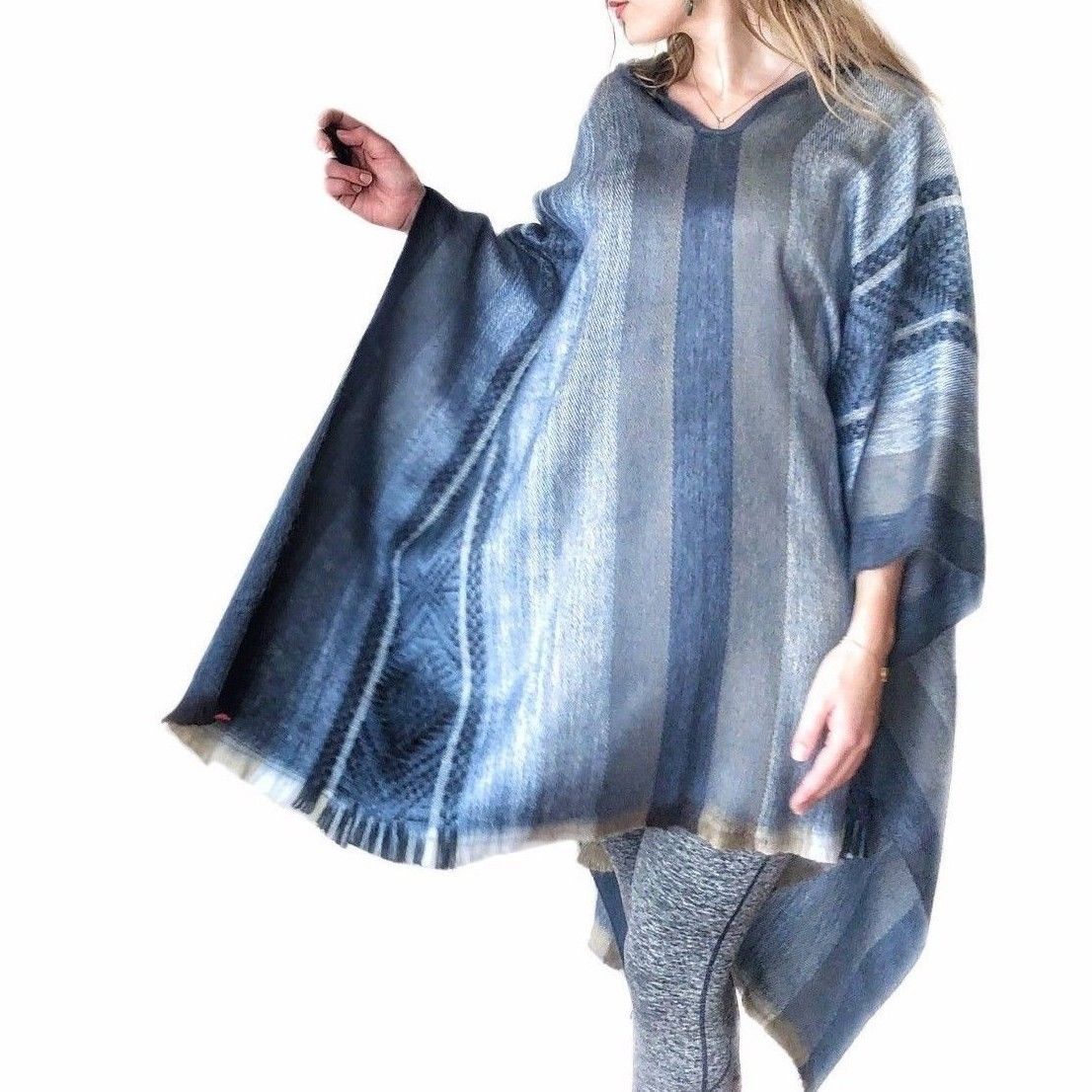 Light baby blue alpaca poncho with gray accents, featuring a cozy hood, perfect for stylish warmth.