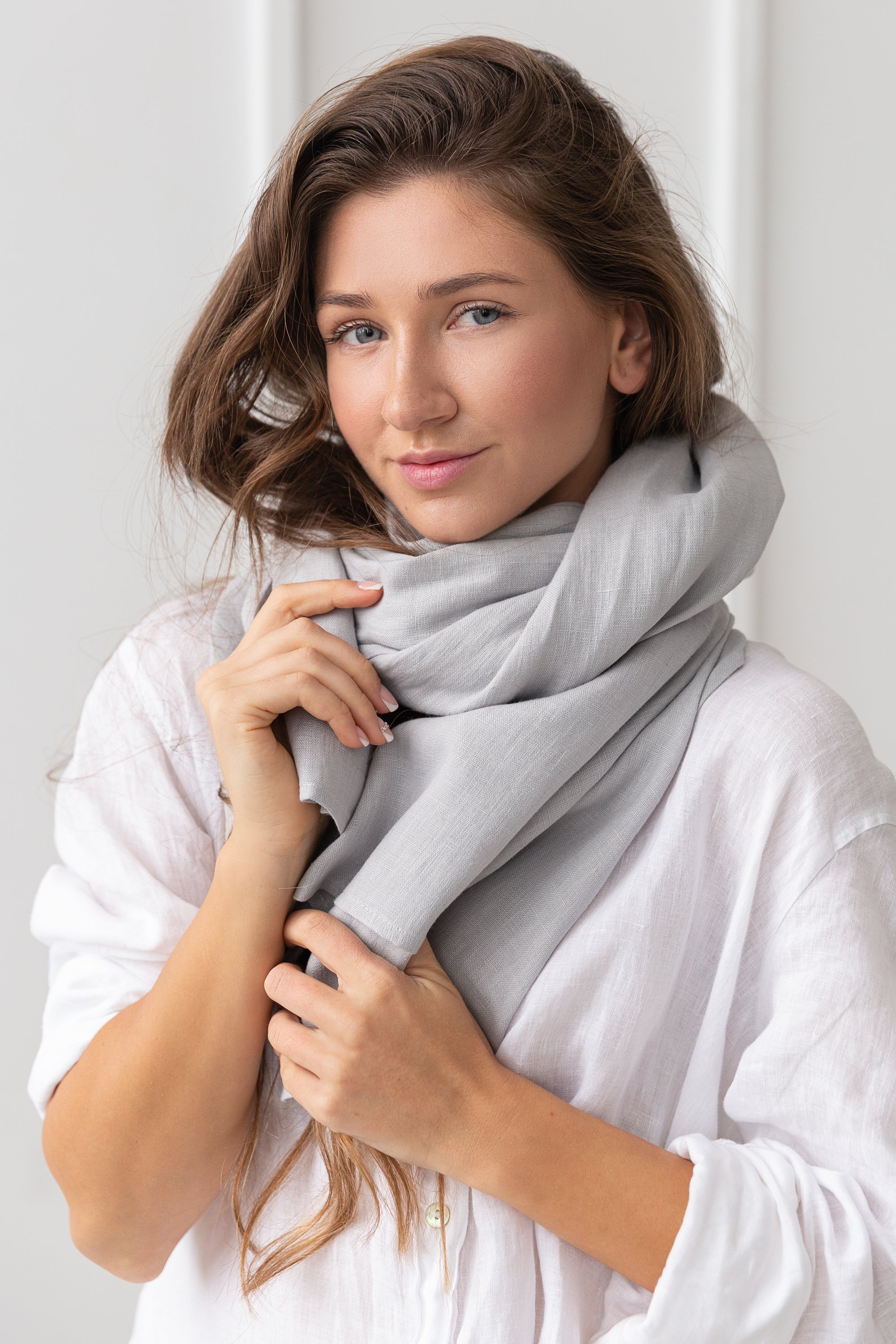 A light grey linen scarf made from 100% stonewashed linen, showcasing its soft texture and elegant design.