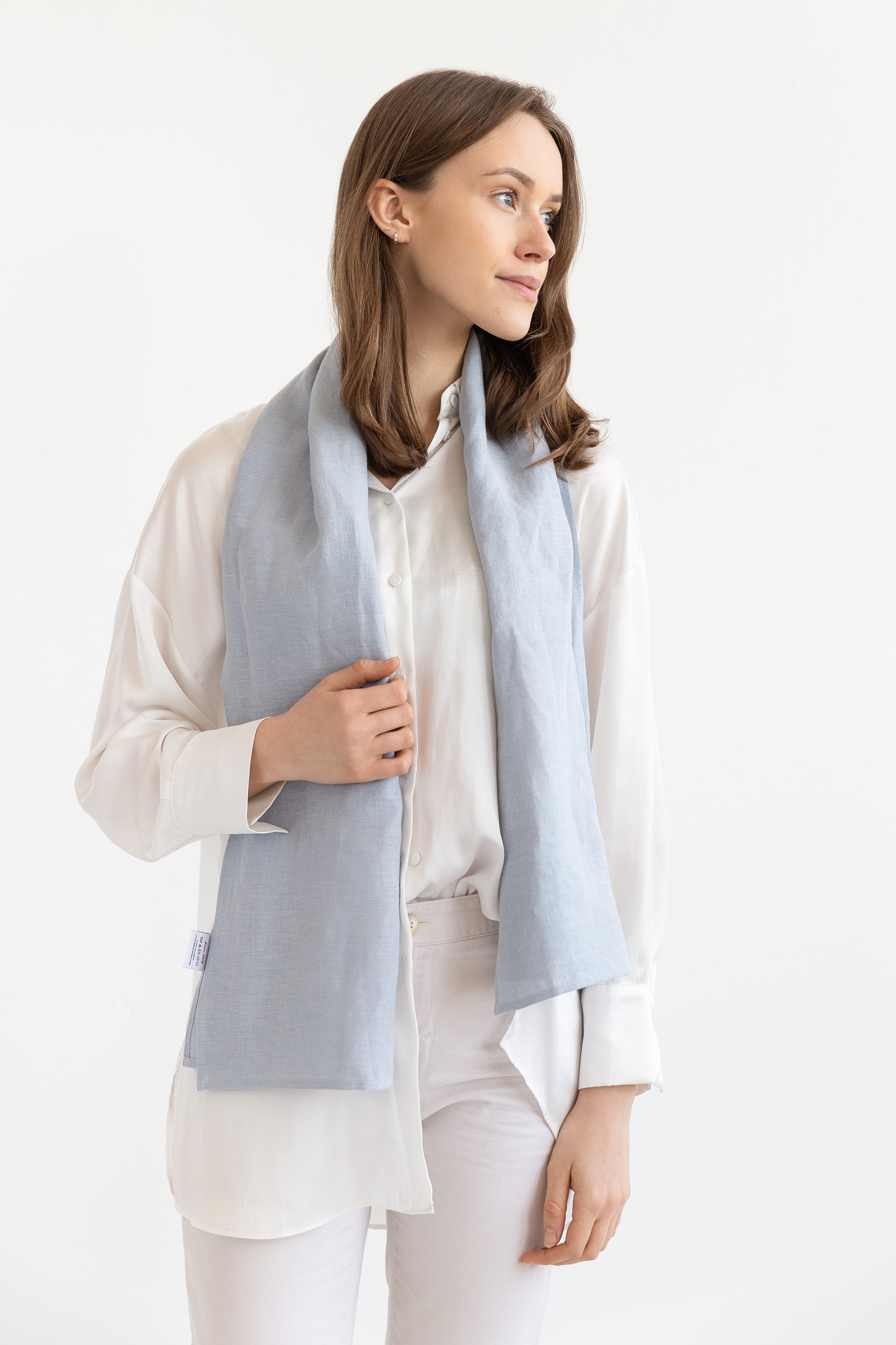 A vibrant collection of lightweight linen scarves in various colors, showcasing their soft texture and stylish design.