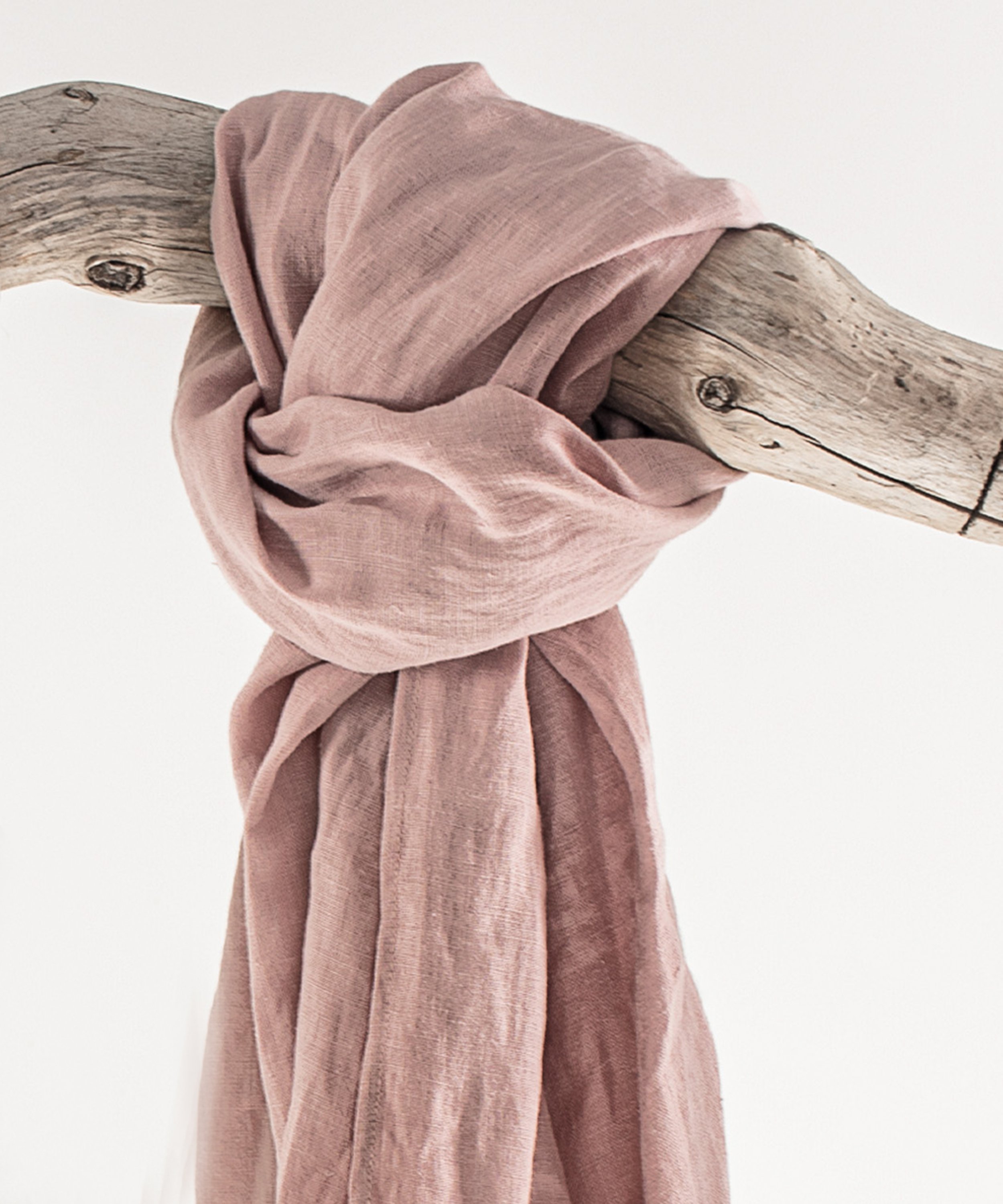 A vibrant collection of lightweight linen scarves in various colors, showcasing their soft texture and stylish design.