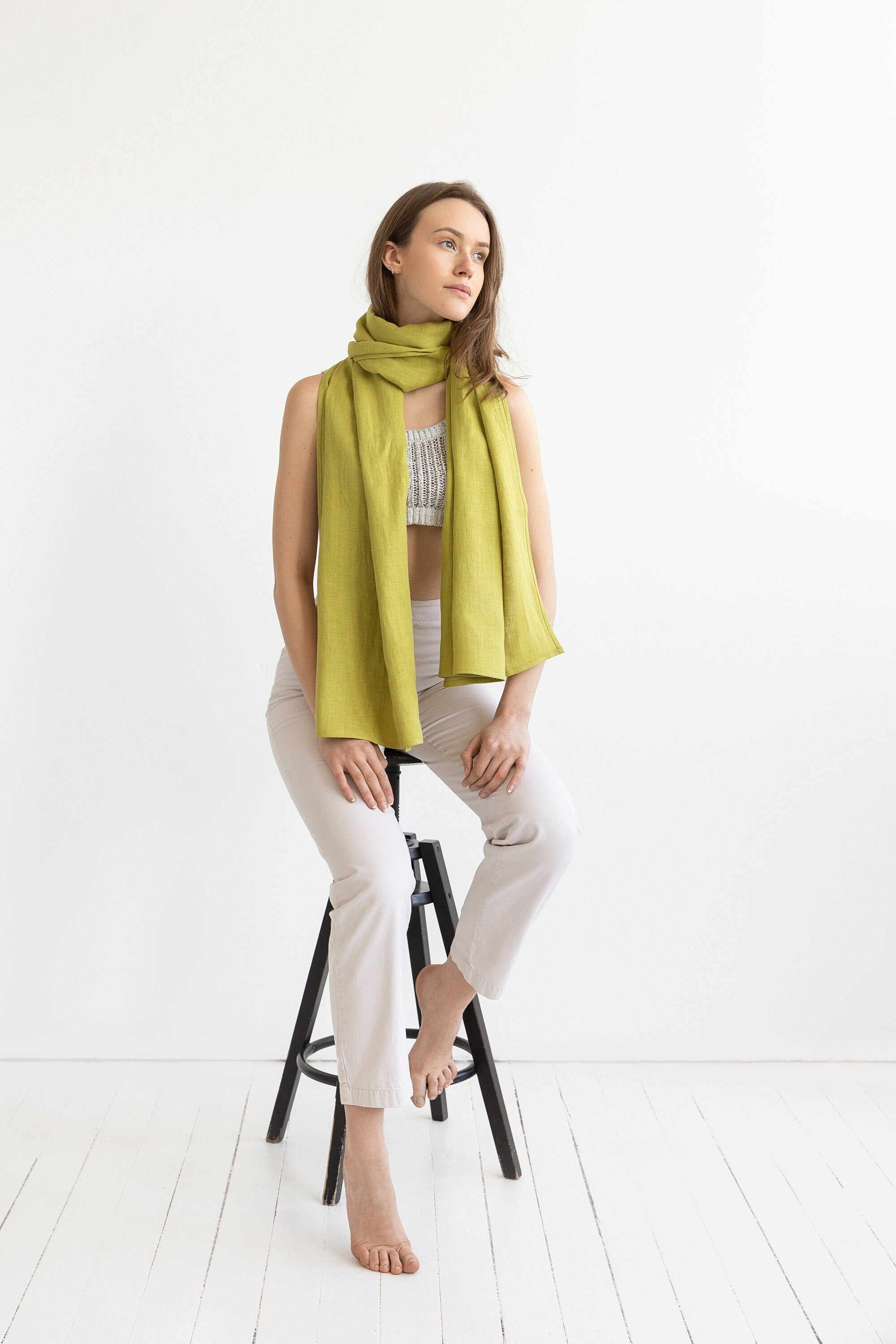 A bright Pear colored linen scarf made from 100% stonewashed linen, showcasing its soft texture and lightweight design.