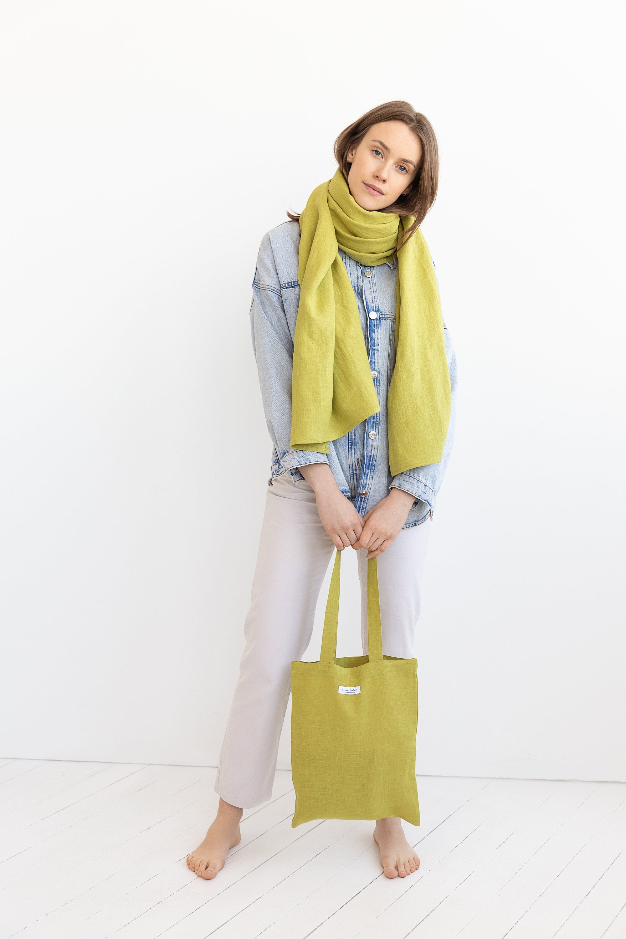 A bright Pear colored linen scarf made from 100% stonewashed linen, showcasing its soft texture and lightweight design.