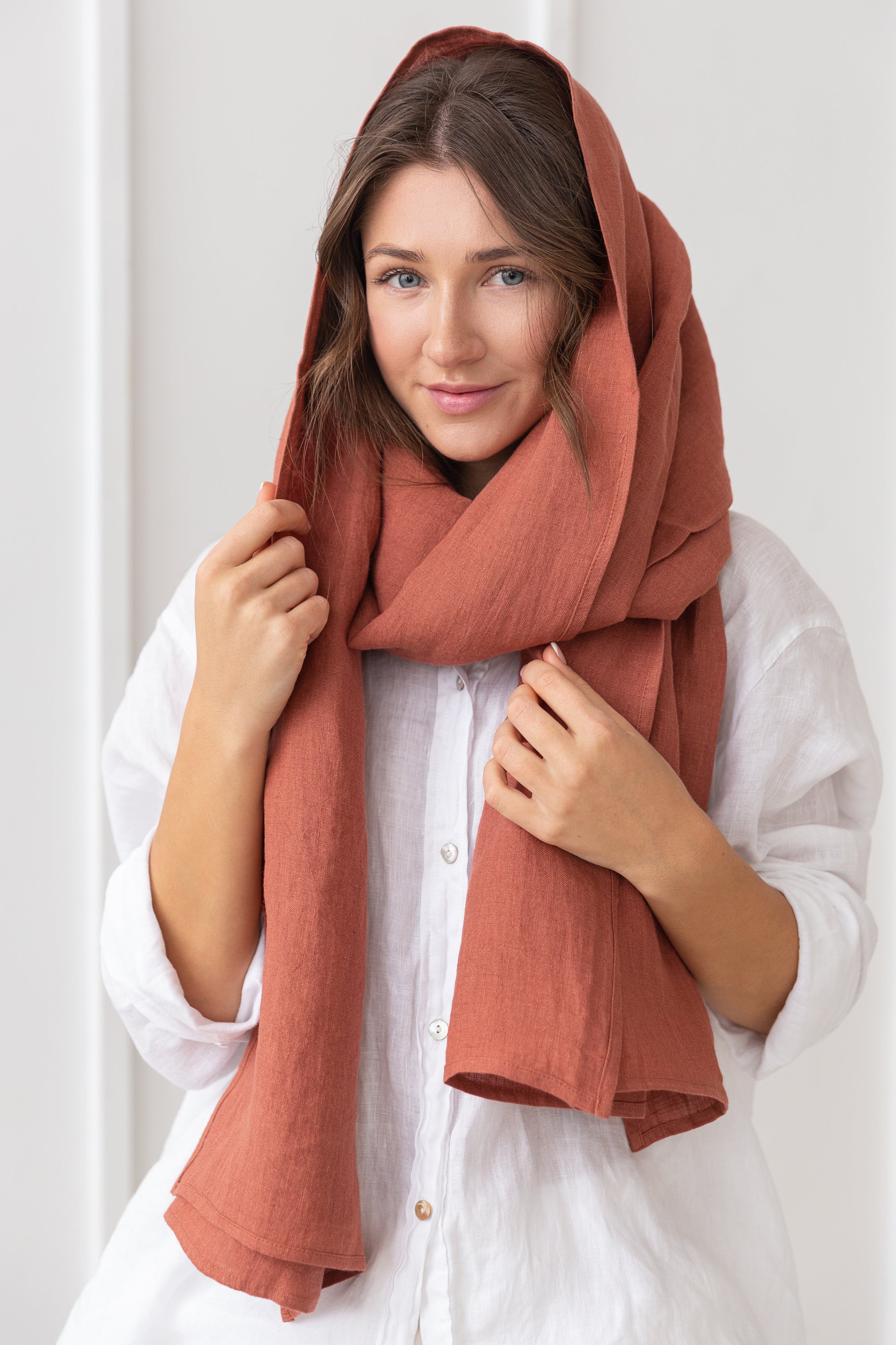 A stylish reddish brown linen scarf made from 100% stonewashed linen, showcasing its soft texture and elegant design.