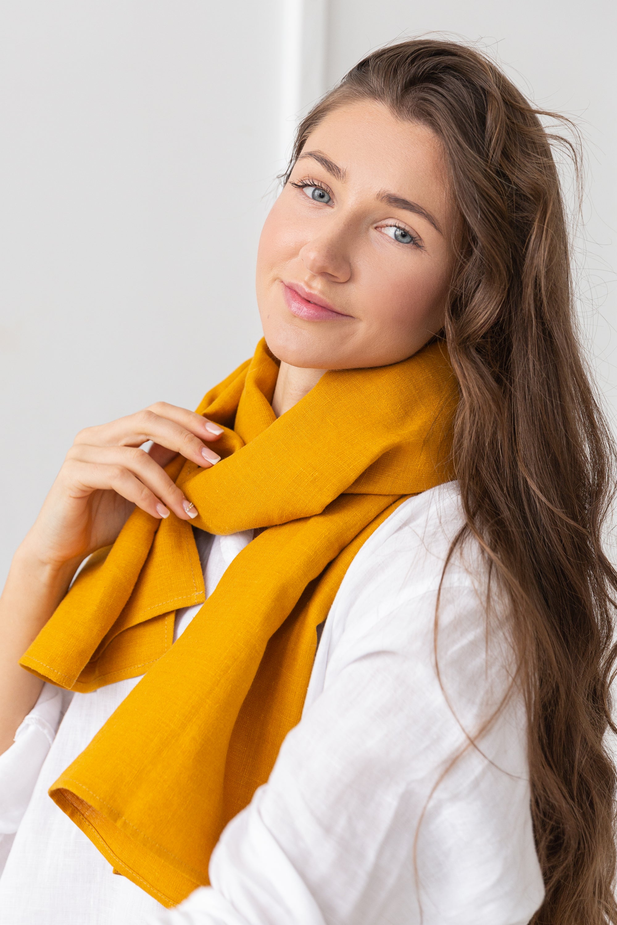 A stylish reddish brown linen scarf made from 100% stonewashed linen, showcasing its soft texture and elegant design.